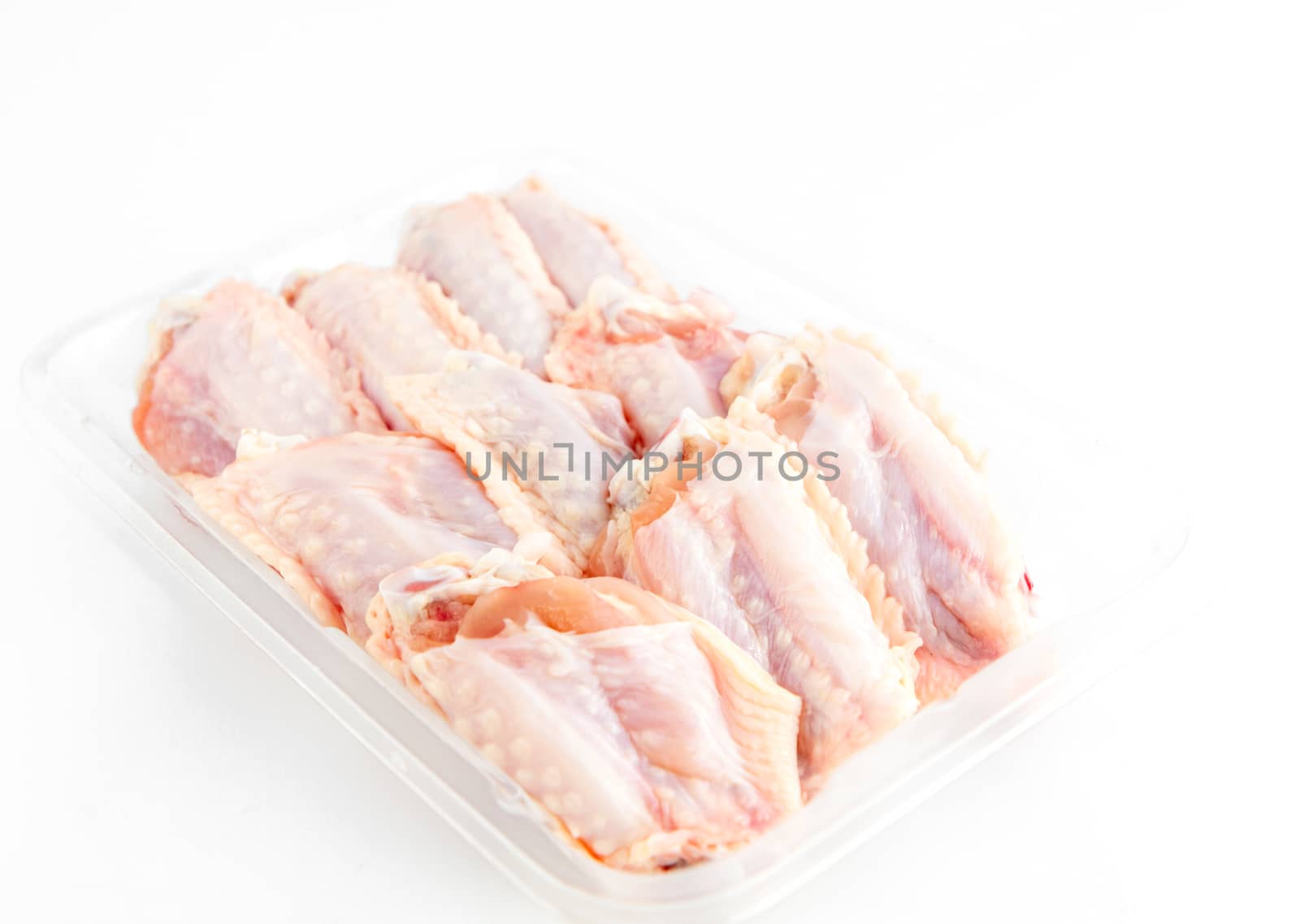 fresh Chicken middle wings in package on white background by bunwit