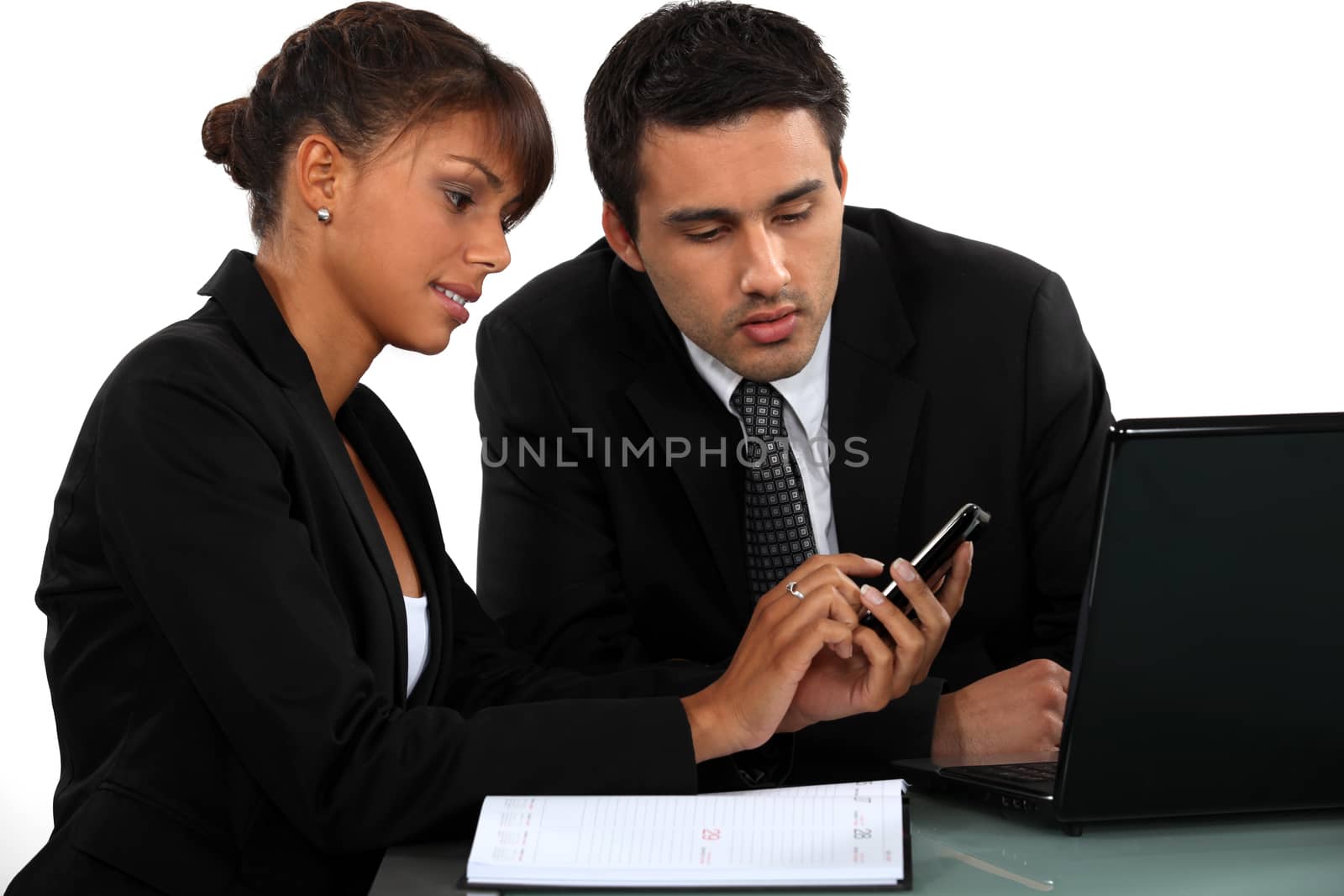 Businesspeople looking at a mobile phone