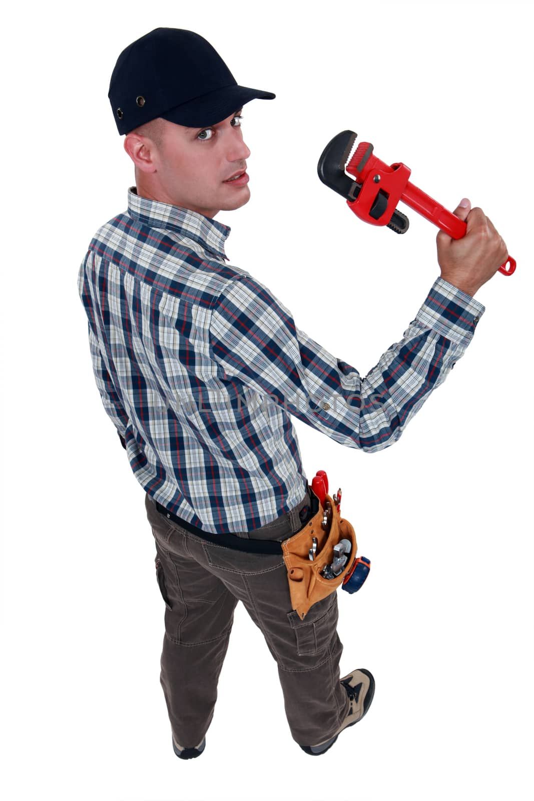 Worker with an adjustable pipe wrench by phovoir