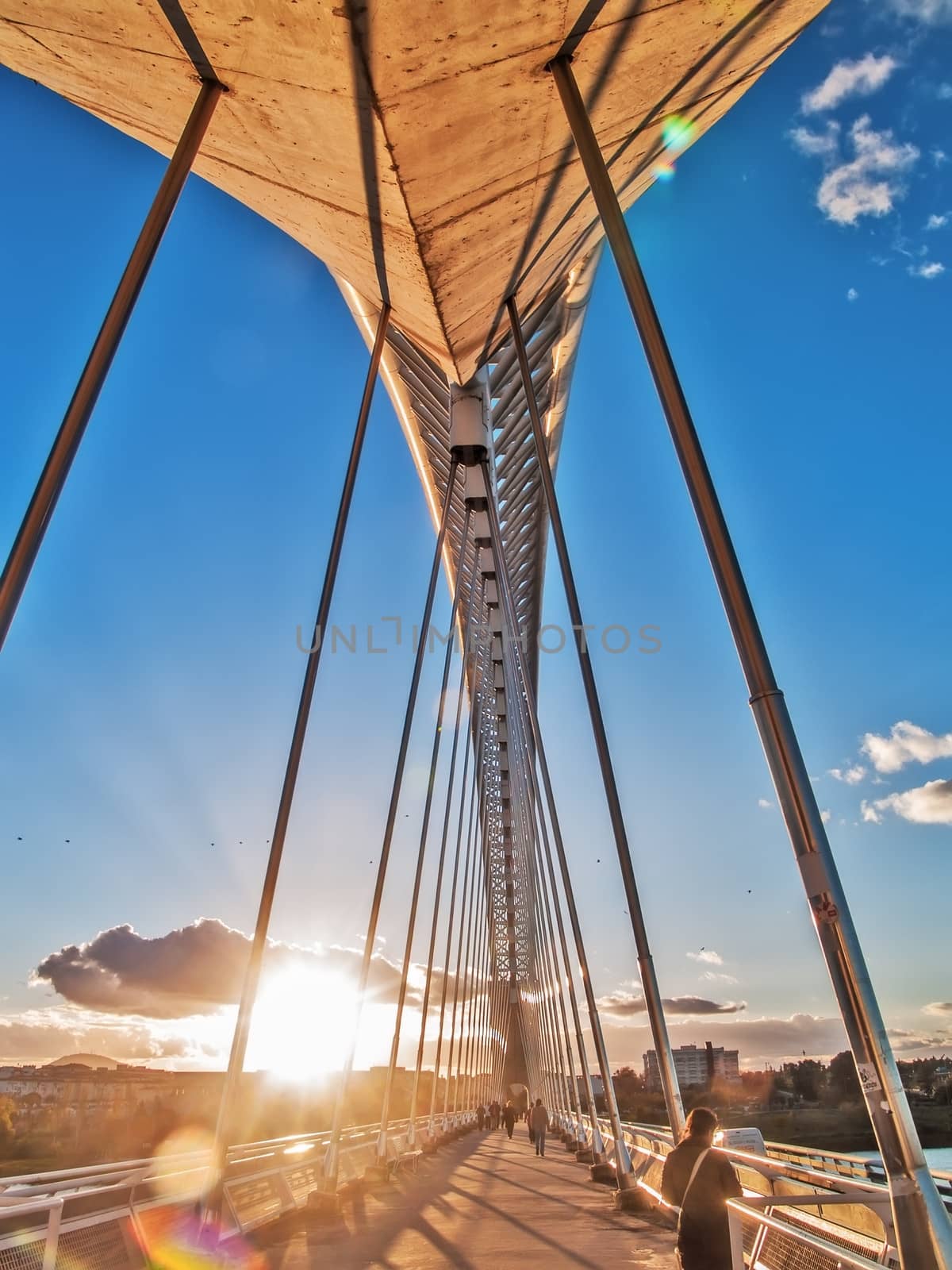 Merida, November 2012. Lusitania bridge over Guadiana river. Santiago Calatrava architect, built in 1991 on concrete and steel. 480 meters. 190 meters of  arch. People walking.