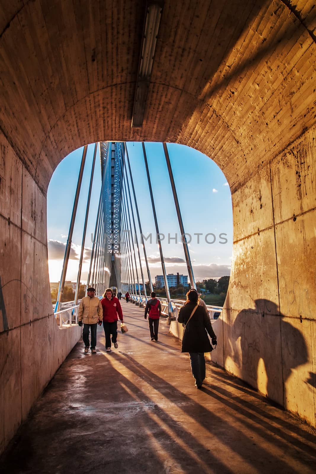 Merida, November 2012. Lusitania bridge over Guadiana river. Santiago Calatrava architect, built in 1991 on concrete and steel. 480 meters. 190 meters of  arch. People walking.