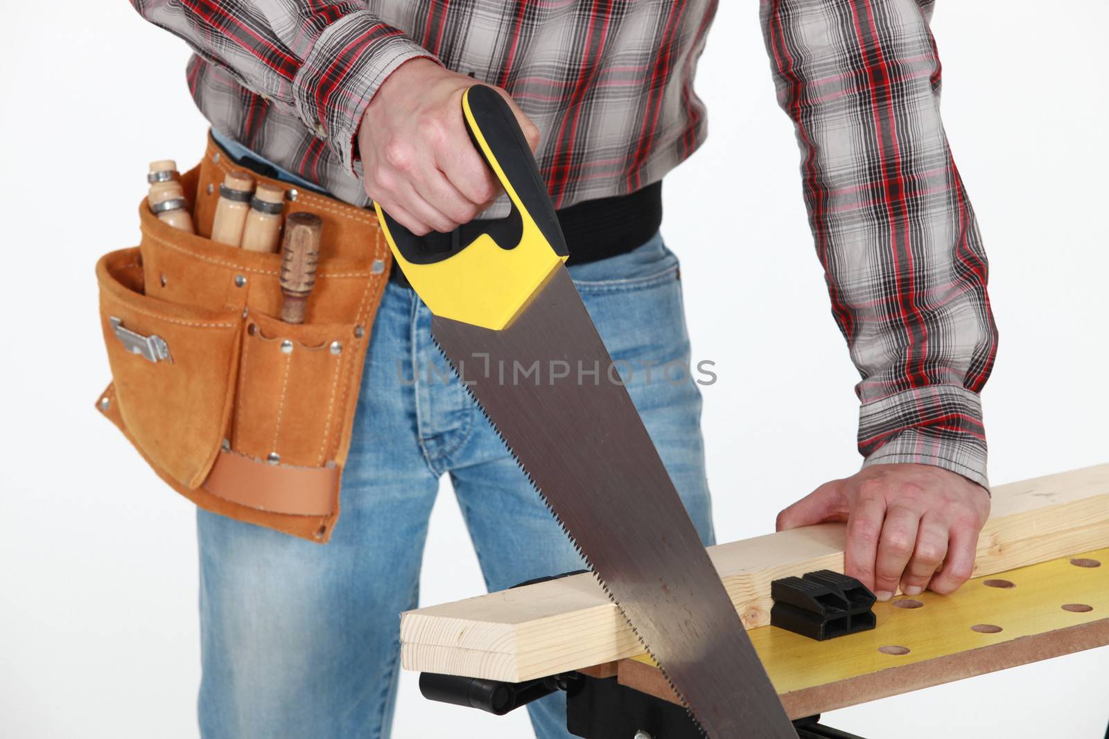 Man sawing plank of wood by phovoir