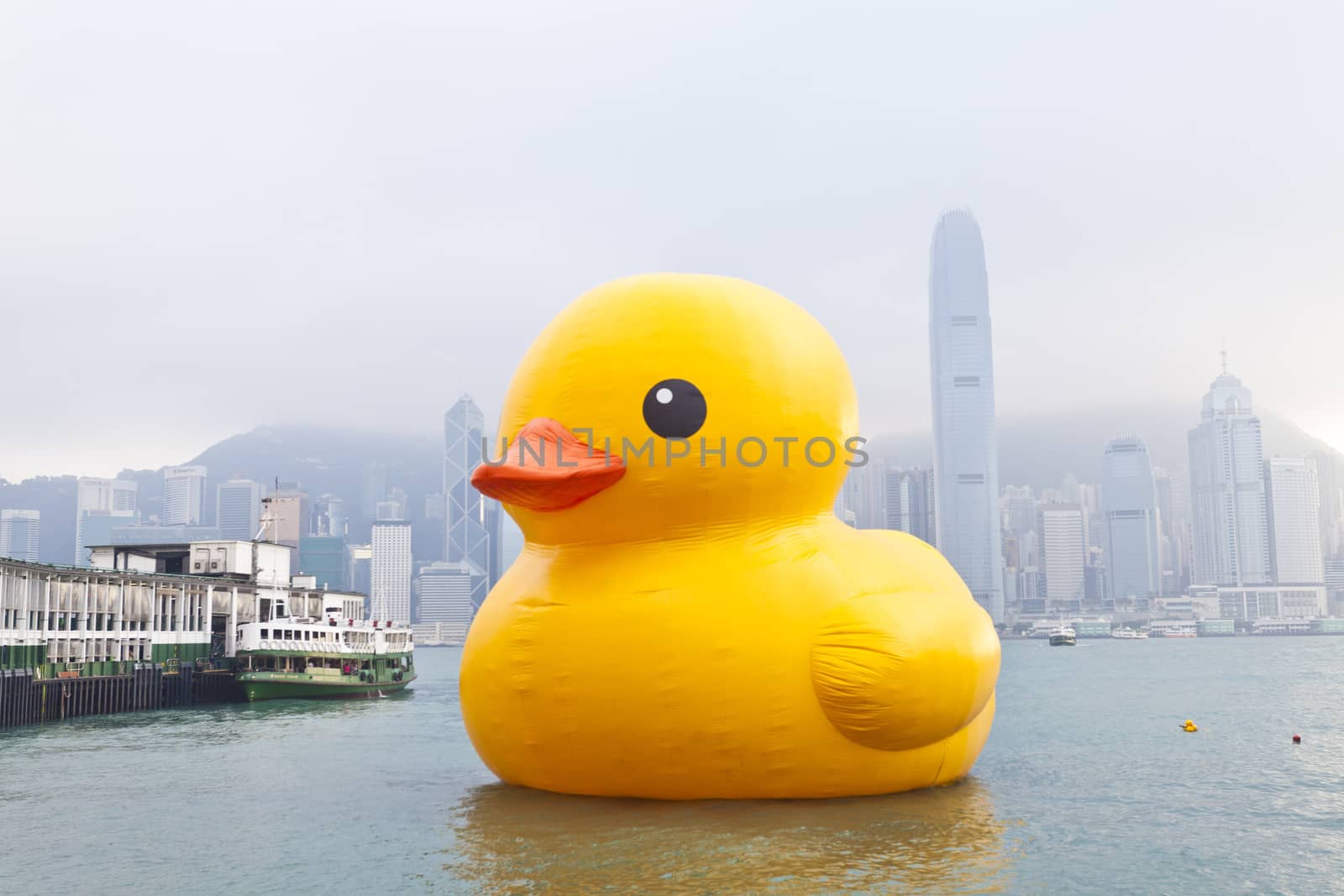 HONG KONG - MAY 6: The rubber duck swim in Victoria Harbour on May 6 2013. Giant 'Rubber Duck' Sculpture By Artist Florentijn Hofman, visit Hong Kong which draw the attention of local.