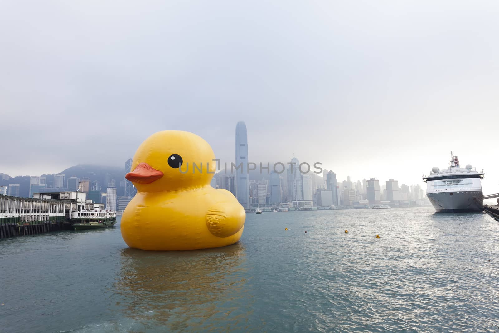 HONG KONG - MAY 6: Giant Rubber Duck floating in Victoria Harbor on May 6, 2013 in Hong Kong. Created by Florentijn Hofman and it's playful presence revive the happiness of life's simple pleasures.