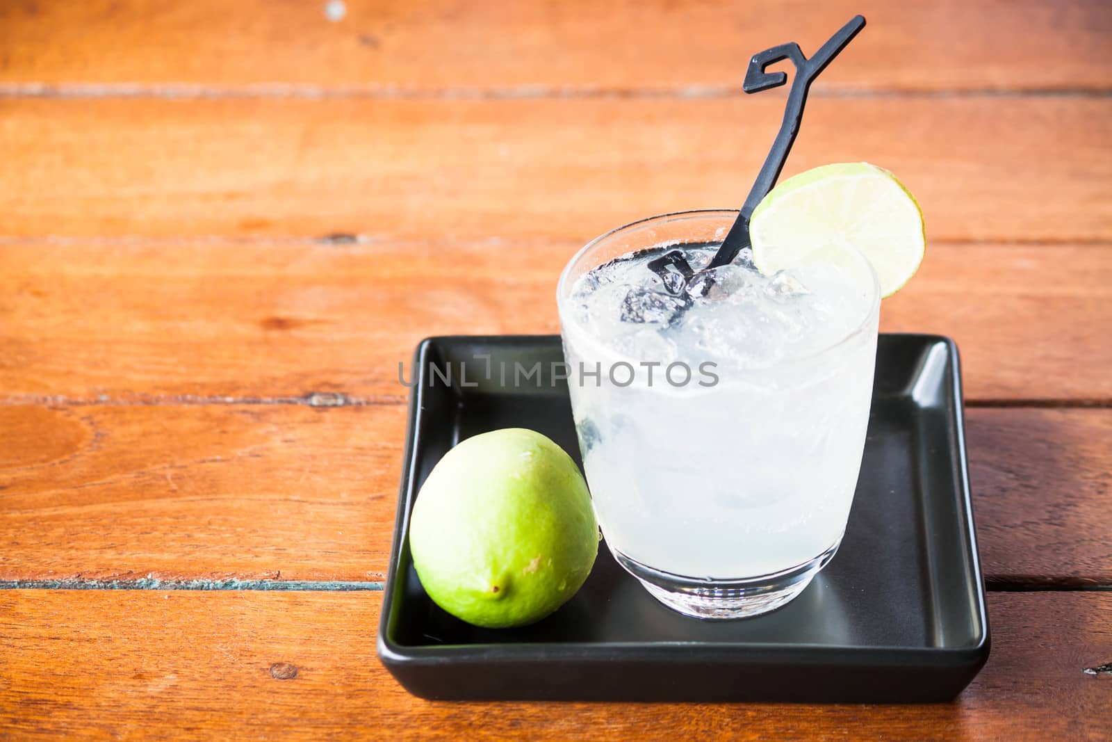 Glass of fresh homemade tasty lemonade soda by punsayaporn