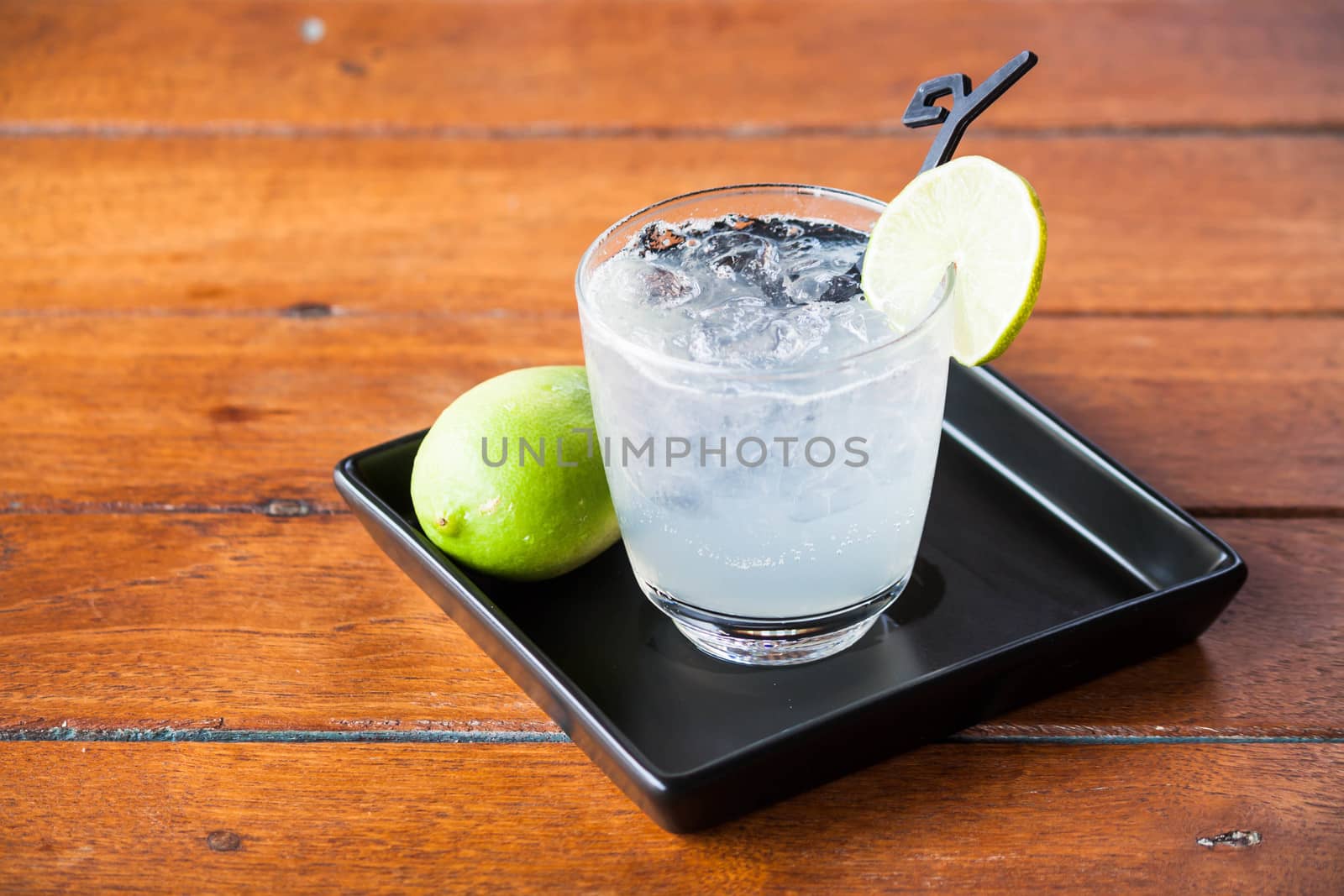 Glass of fresh homemade tasty lemon soda by punsayaporn