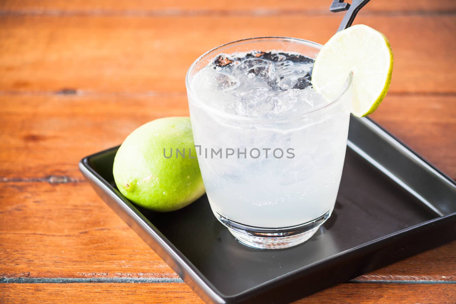 Glass of fresh homemade iced lemon soda by punsayaporn