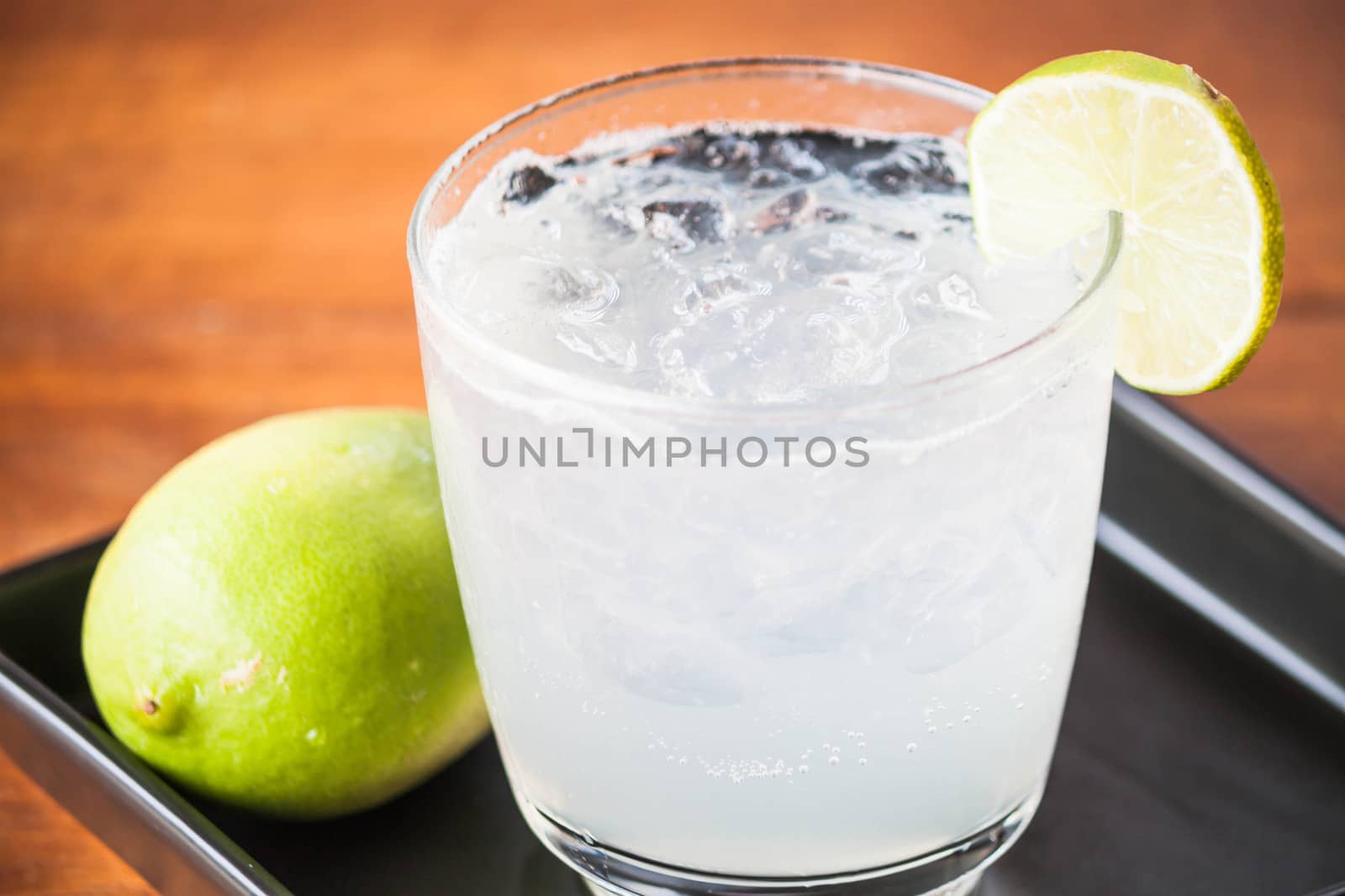 Fresh homemade iced lemon juice soda close up by punsayaporn