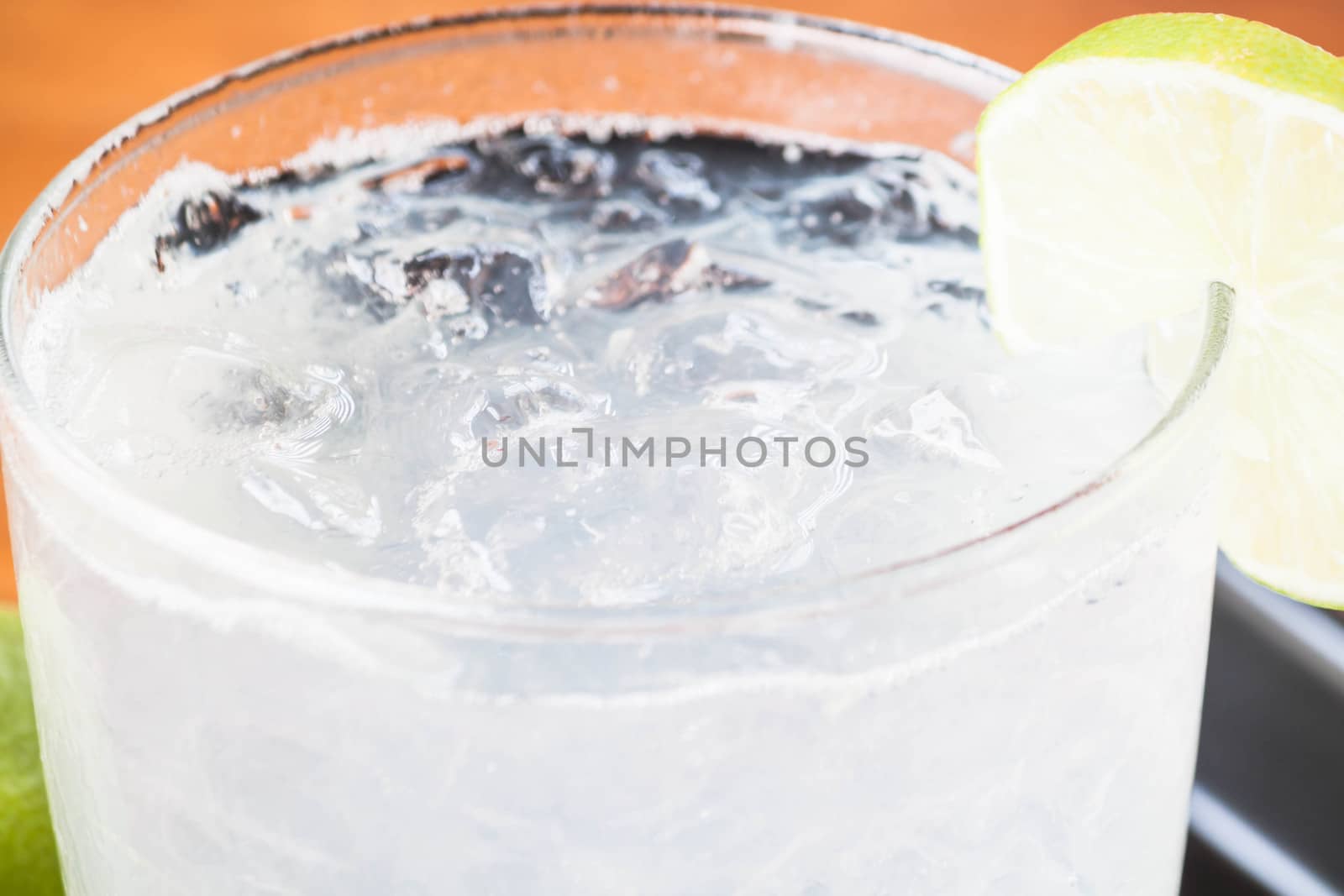 Full glass of fresh cool soda with lime fruit