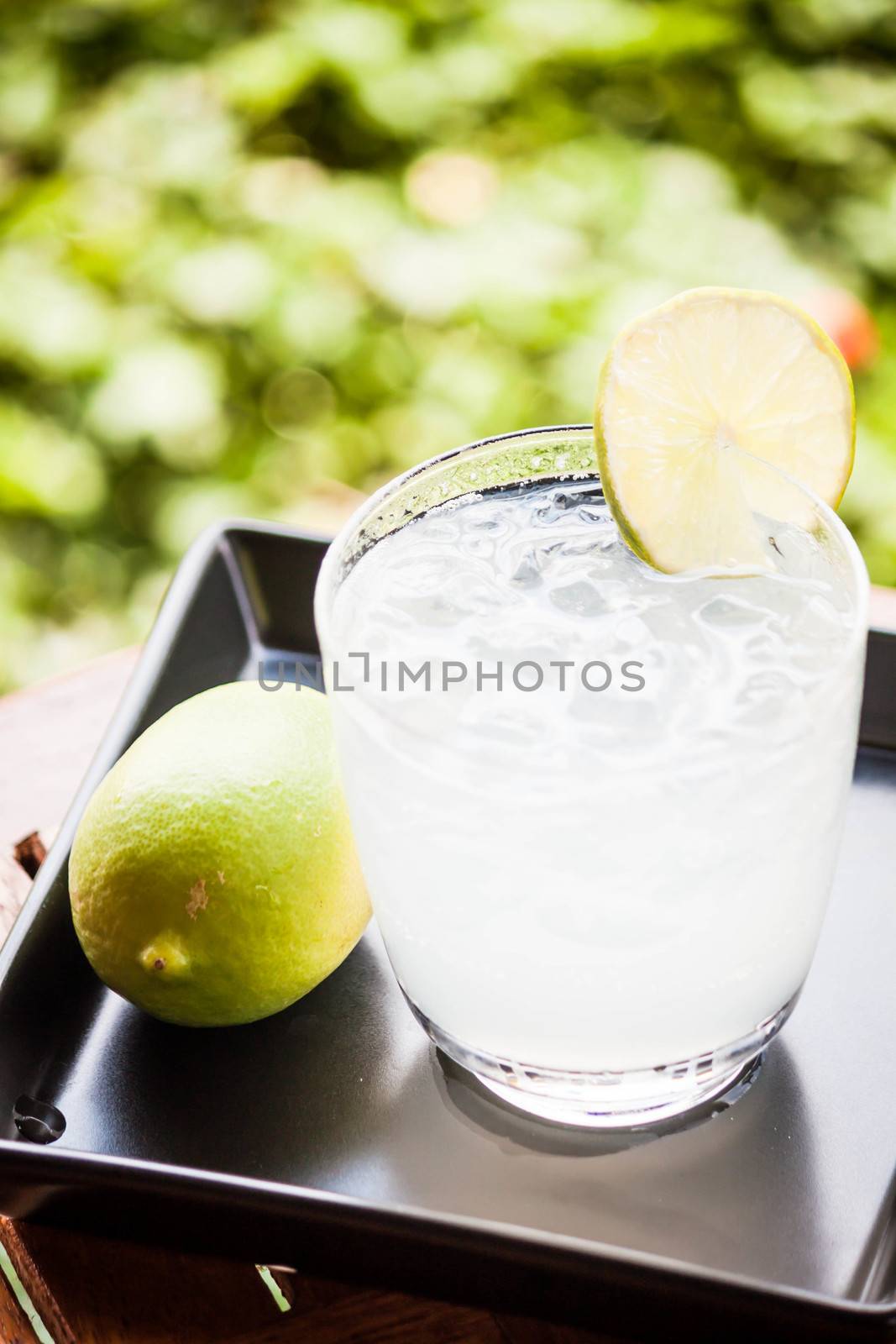 Fresh glass of iced lime juice with lime by punsayaporn