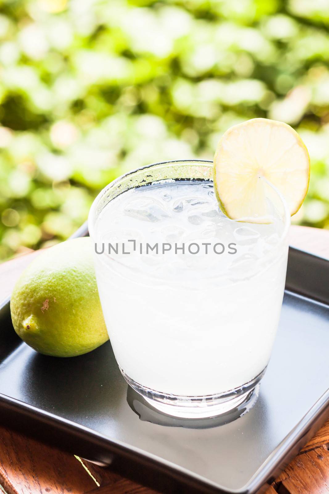 Cold glass of lime juice soda with lime by punsayaporn