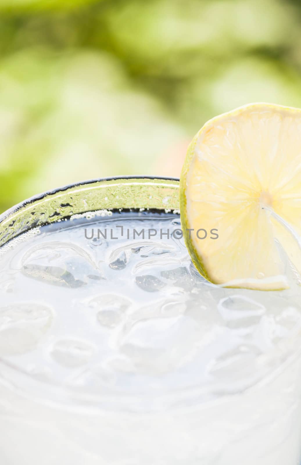 Close up glass of fresh cool soda with lime