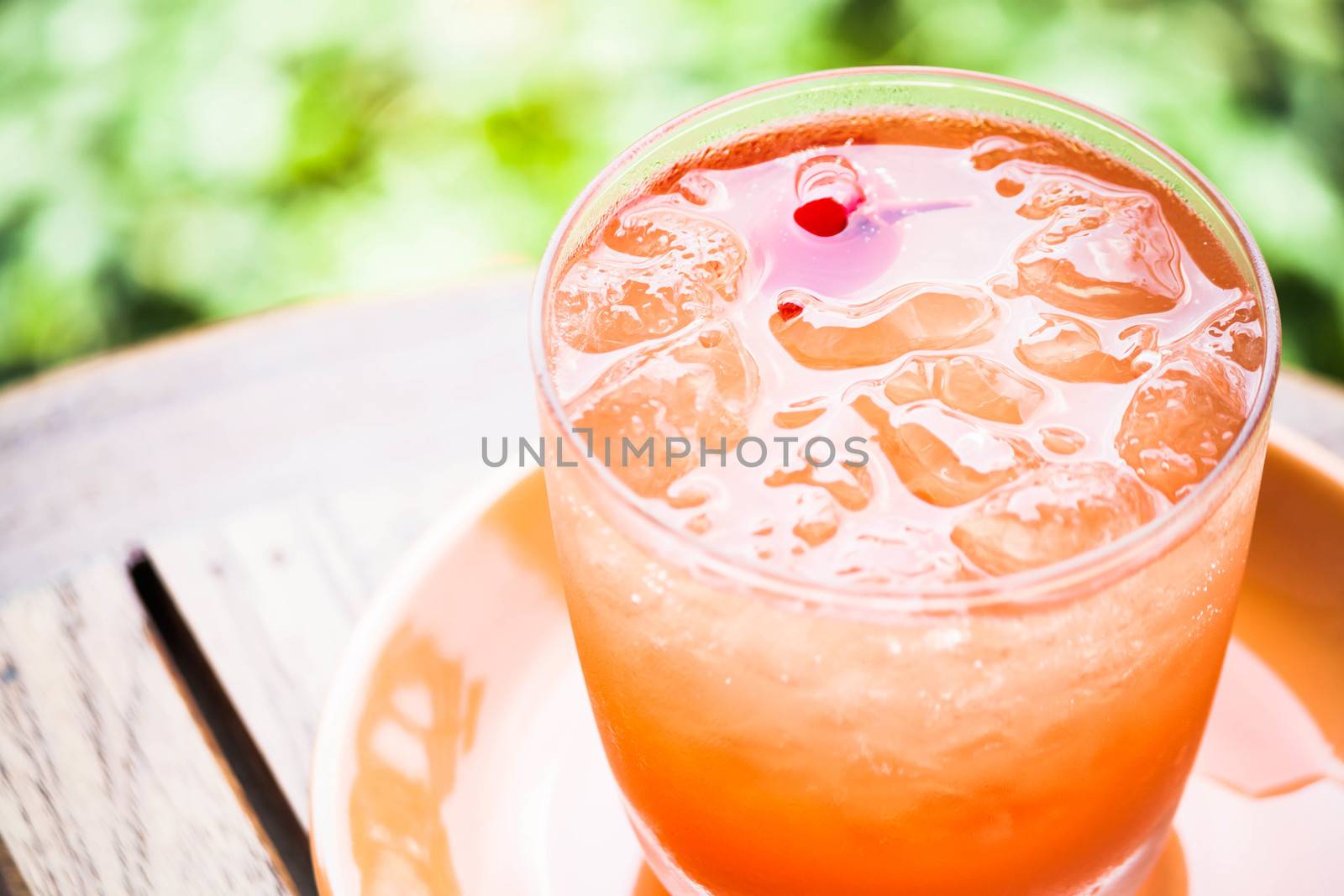 Glass of fresh cool soda with mix fruits juice by punsayaporn