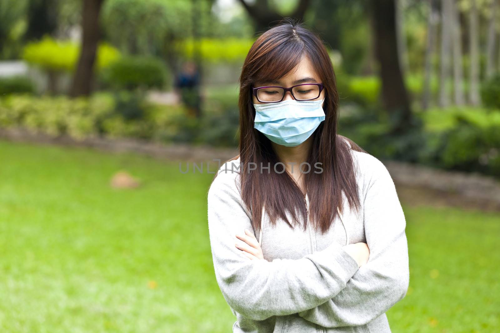 Woman wearing protective face mask in park by kawing921