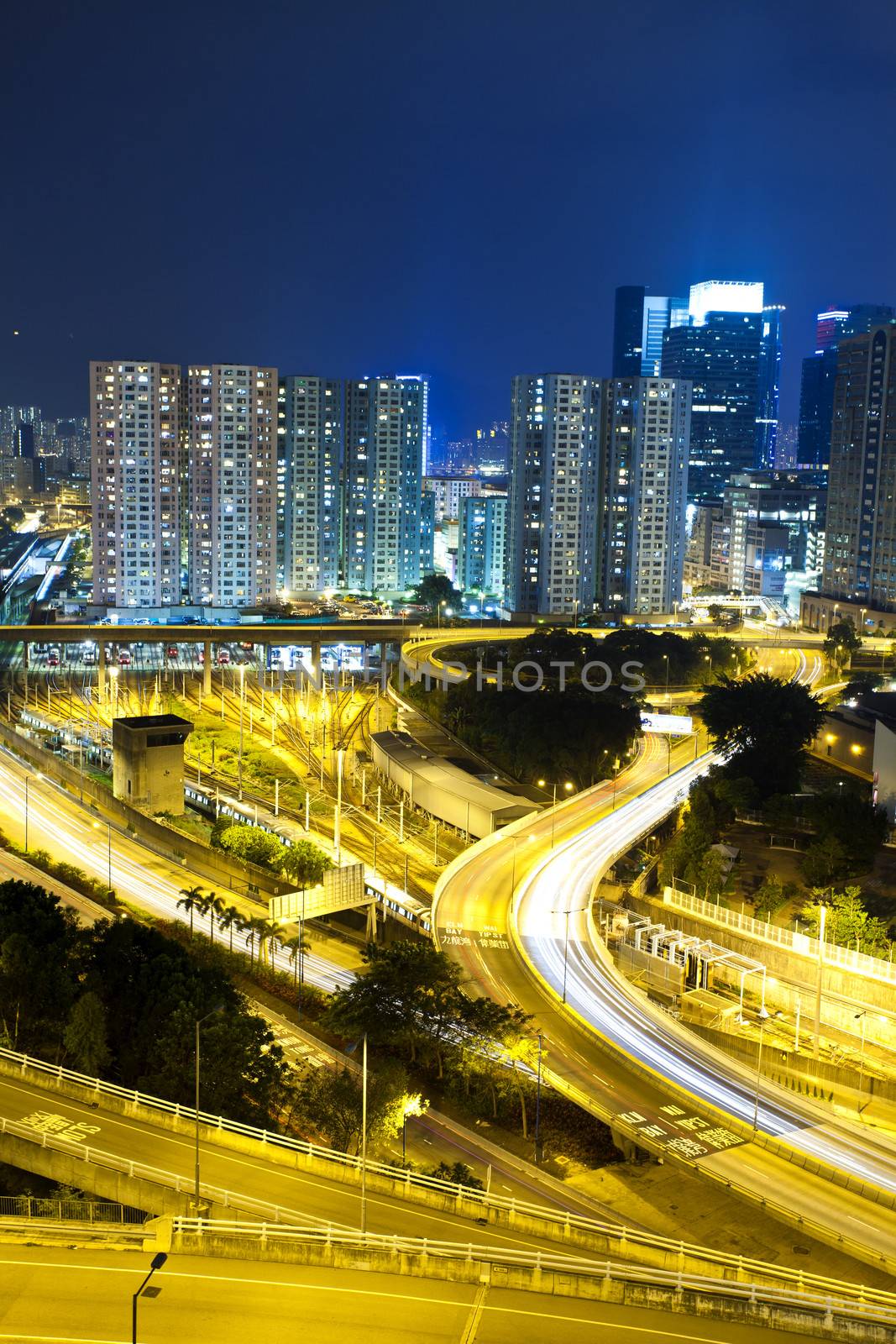 Office buildings and highway in city at night