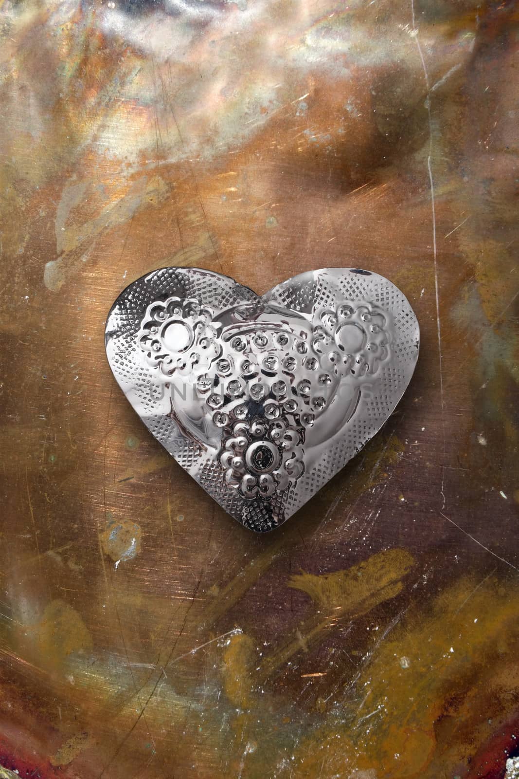 Chrome metal heart on tarnished copper by sumners