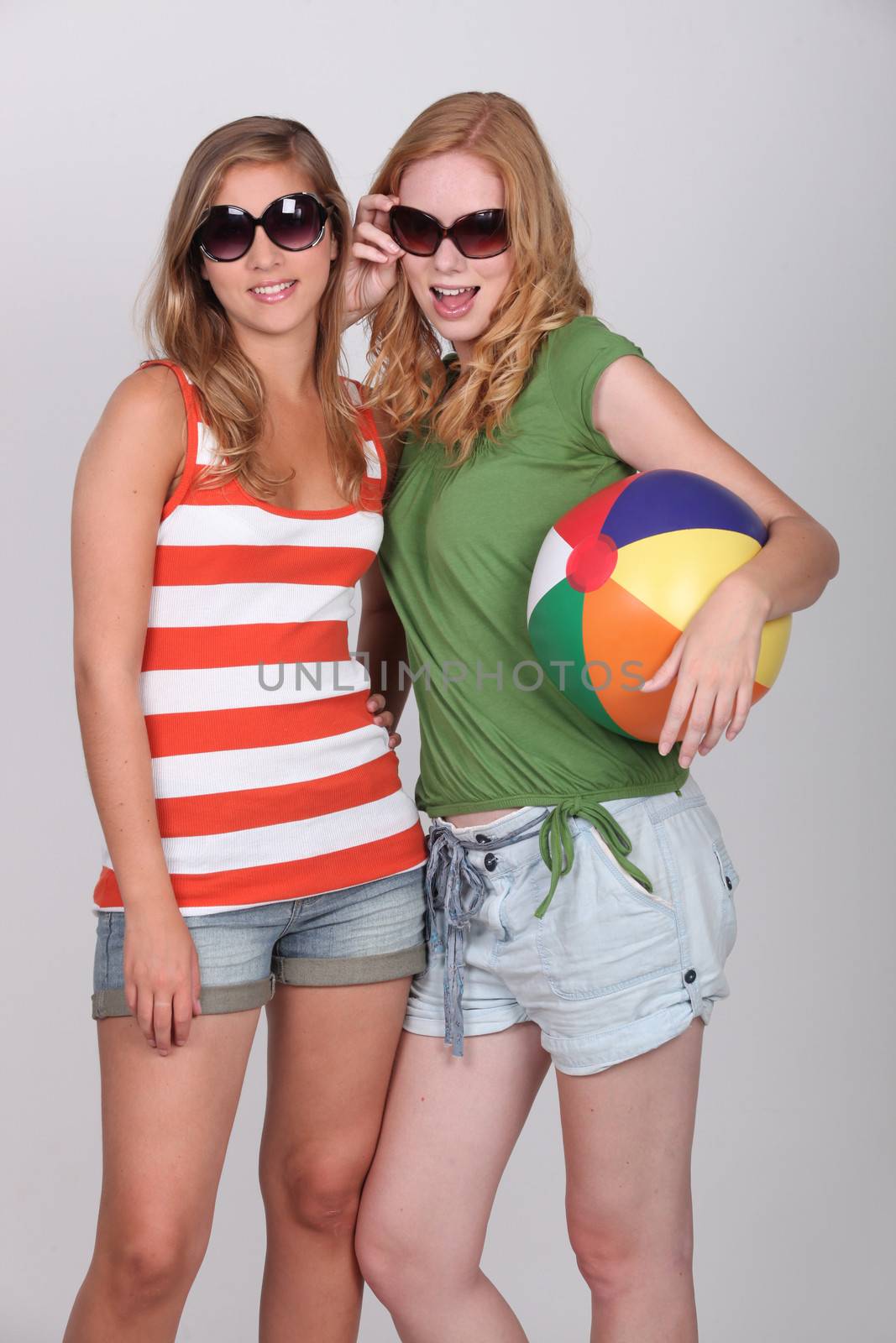 Two teenage girls dressed for summer fun by phovoir