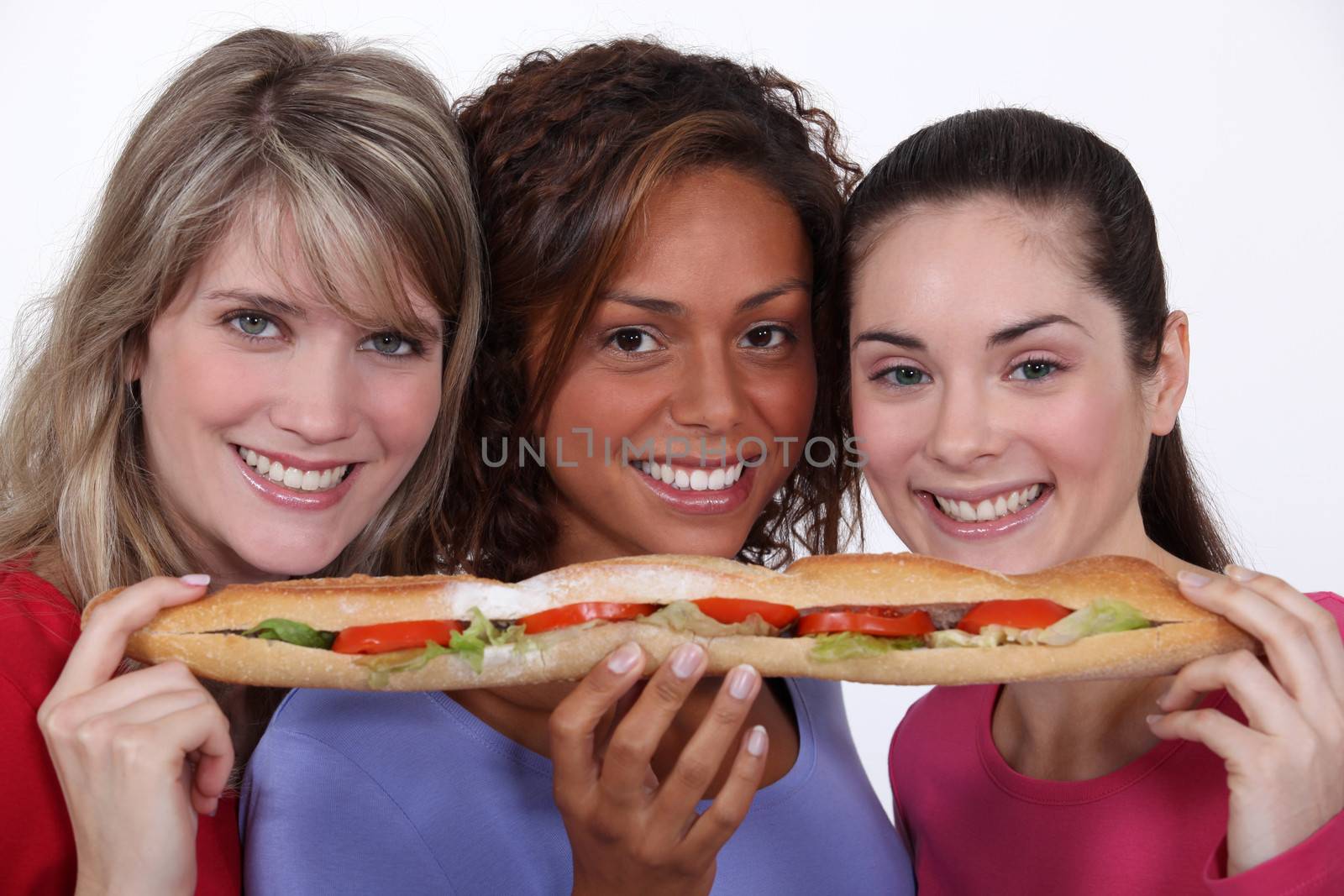 trio of girls eating giant sandwich by phovoir