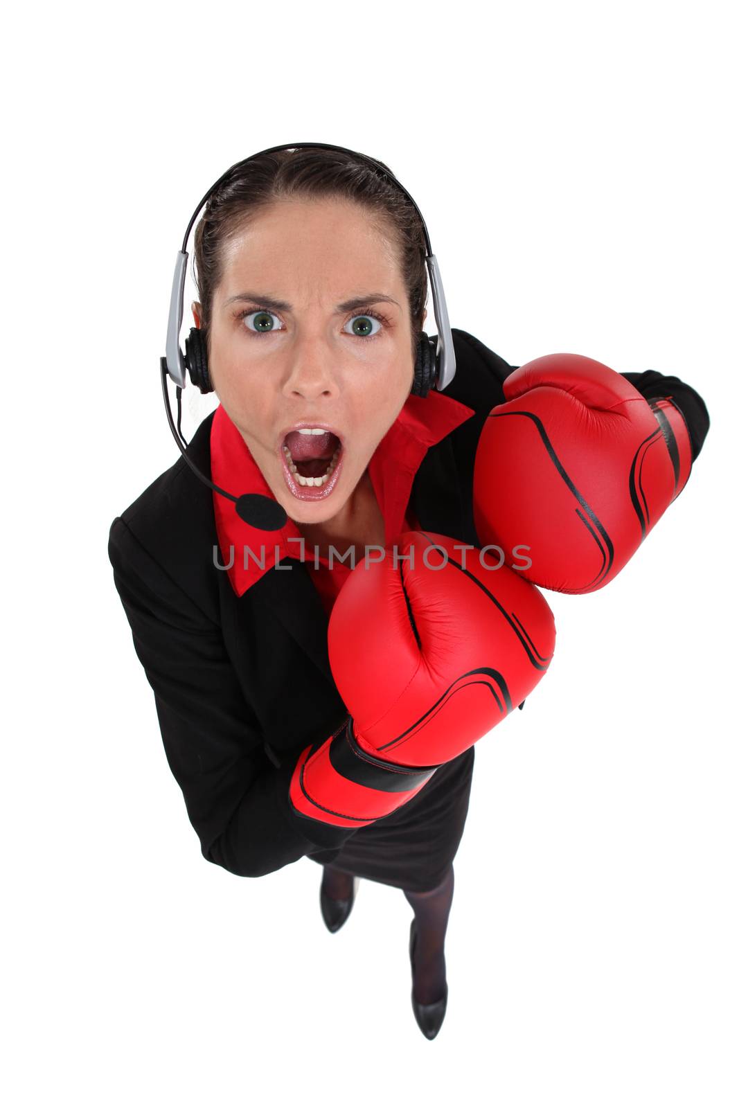 Businesswoman earing boxing gloves by phovoir