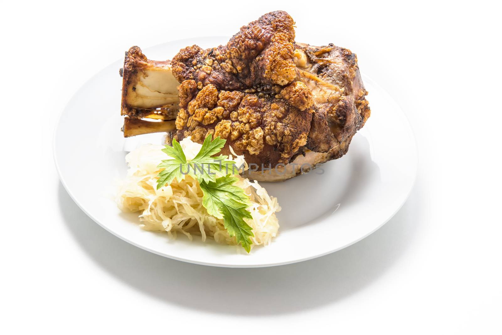 Oktoberfest pork hock on a white plate isolated