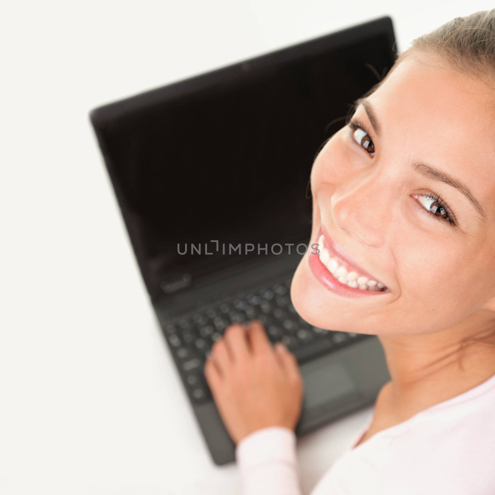 Laptop woman smiling working on computer pc by Ariwasabi
