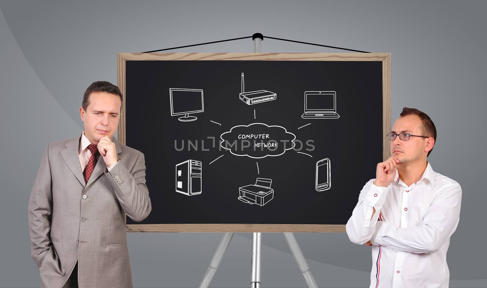 two businessman and  computer network on blackboard