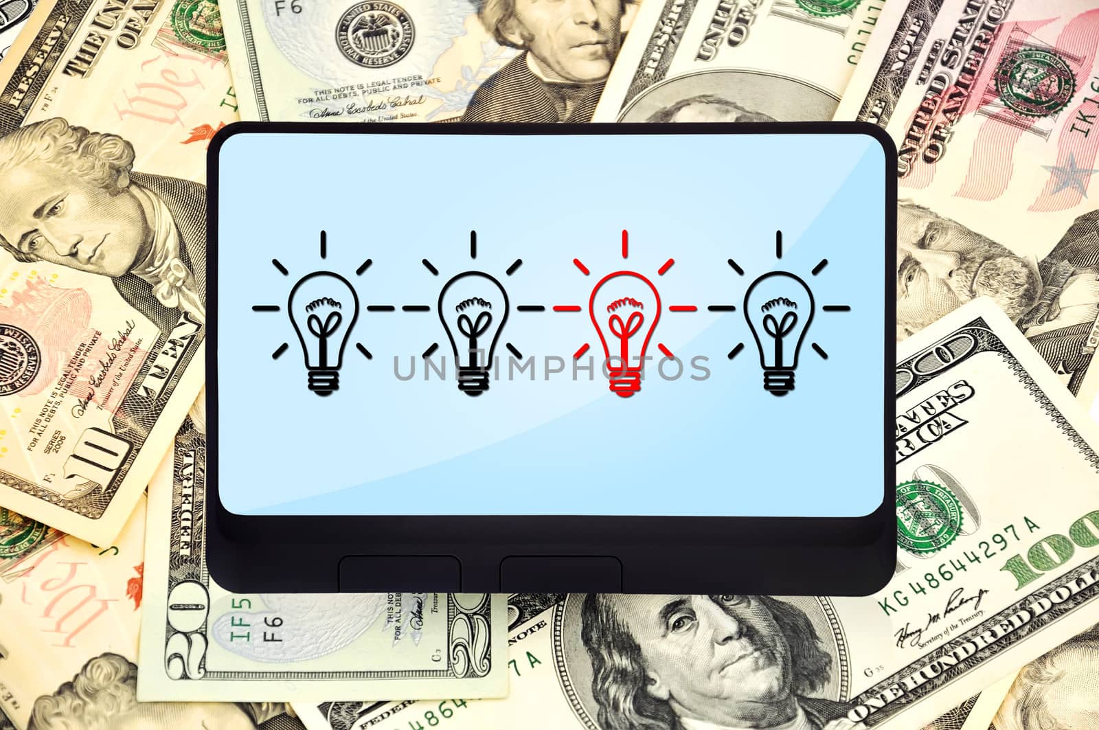 digital tablet with lamps on background of dollars