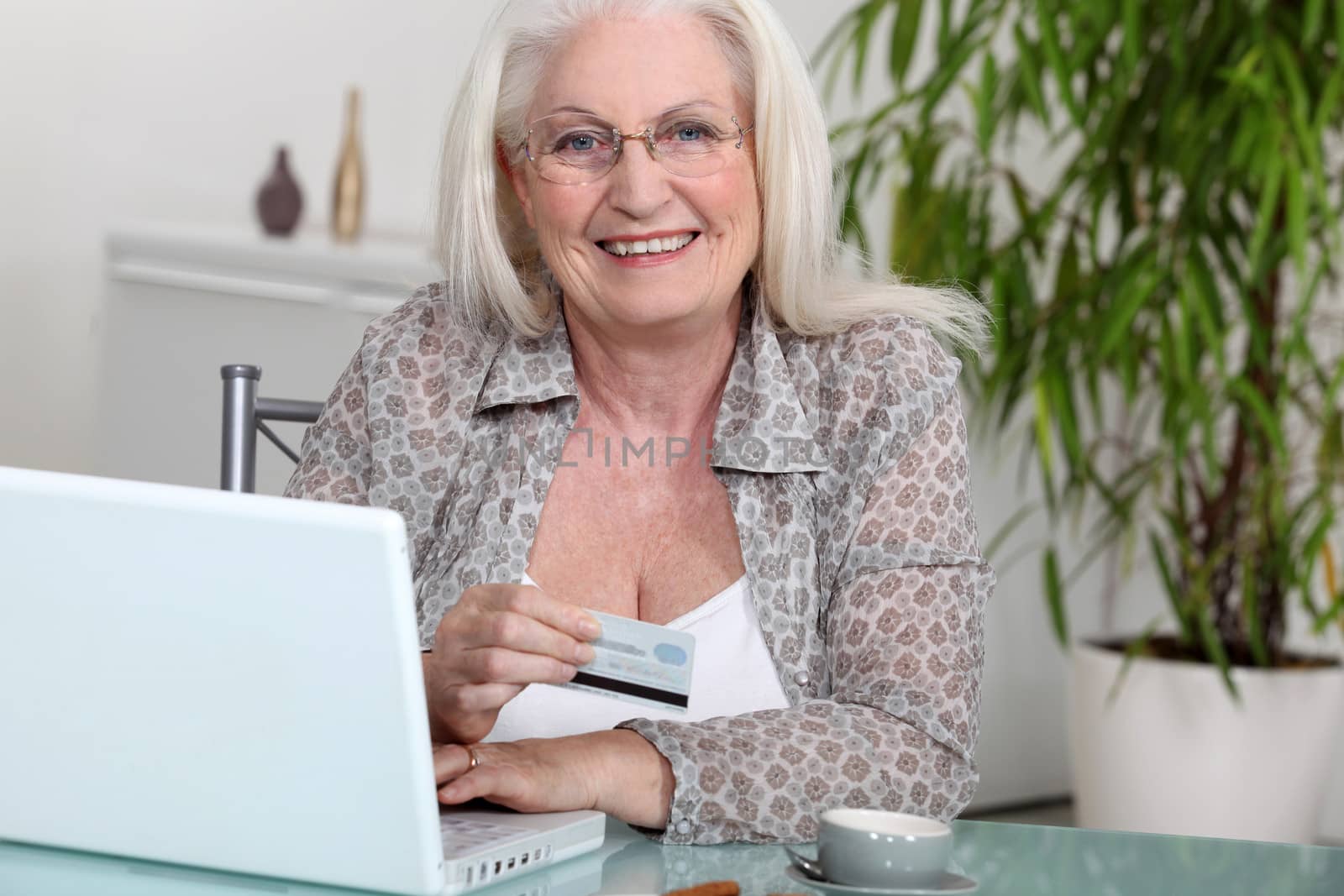 Senior woman paying online by phovoir