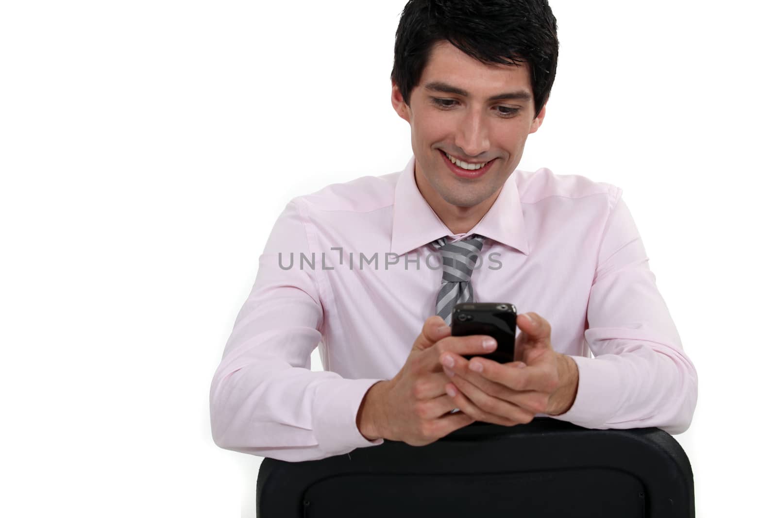 Businessman sending text message by phovoir