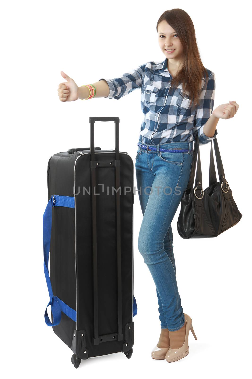 Teen girl 16 years old, with a big, black travel bag on wheels. Girl hitchhiking. Girl 16 years old in jeans and a plaid shirt, hitchhiking or taxi stops. One person, teenager, female, vertical image, isolated on white background.