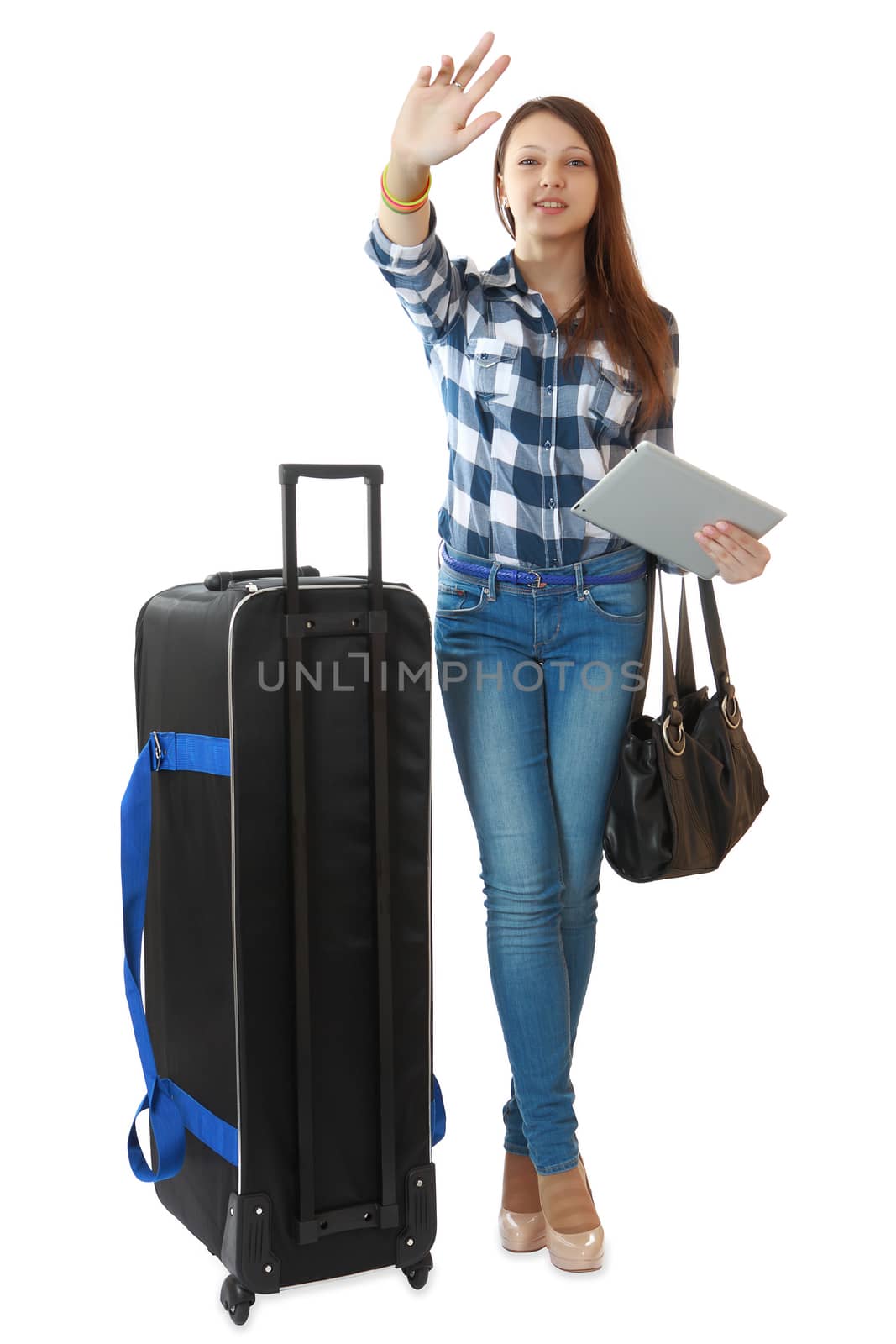 Young traveler with a huge, black travel bag on wheels, waving his hand, drawing the attention of greeters. by grigvovan