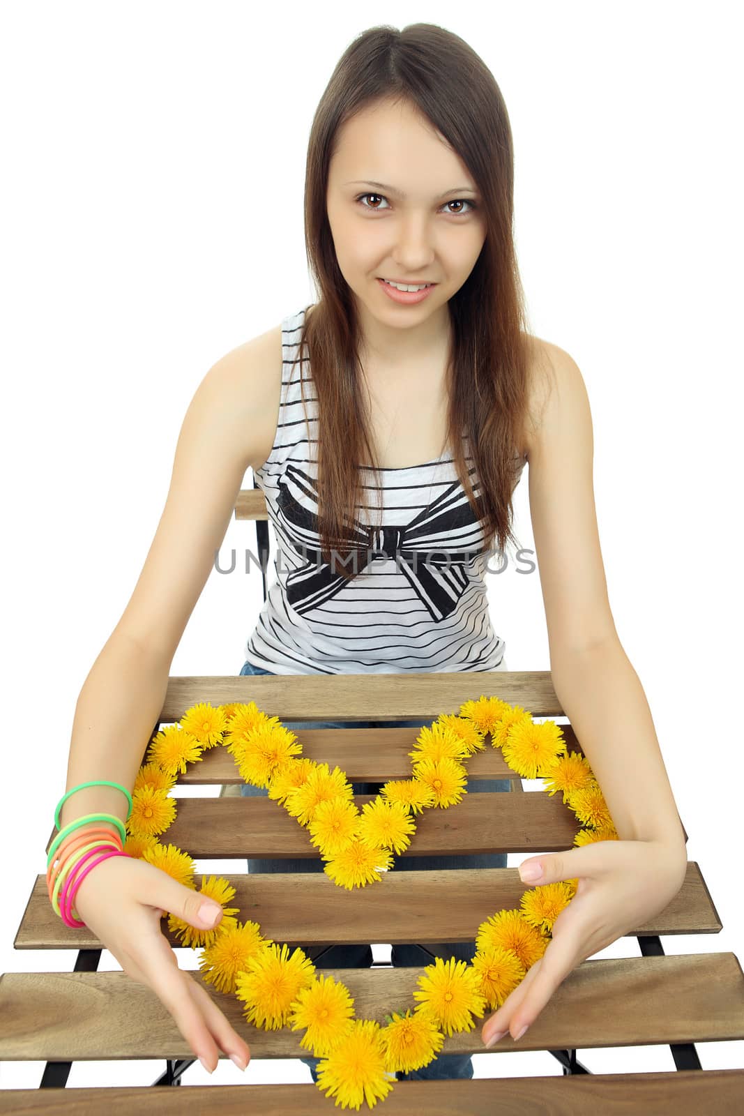 One Caucasian teen girl 16 years old, holds a heart of yellow dandelion flowers.  Young, beautiful girl holding a heart composed of yellow dandelion flowers. One person, Caucasian, female, teenager, vertical image, isolated on white background.