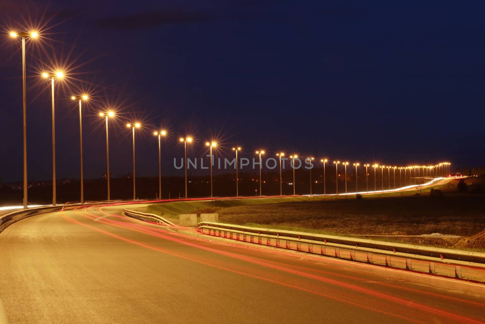 Mast road lighting, night road. by grigvovan