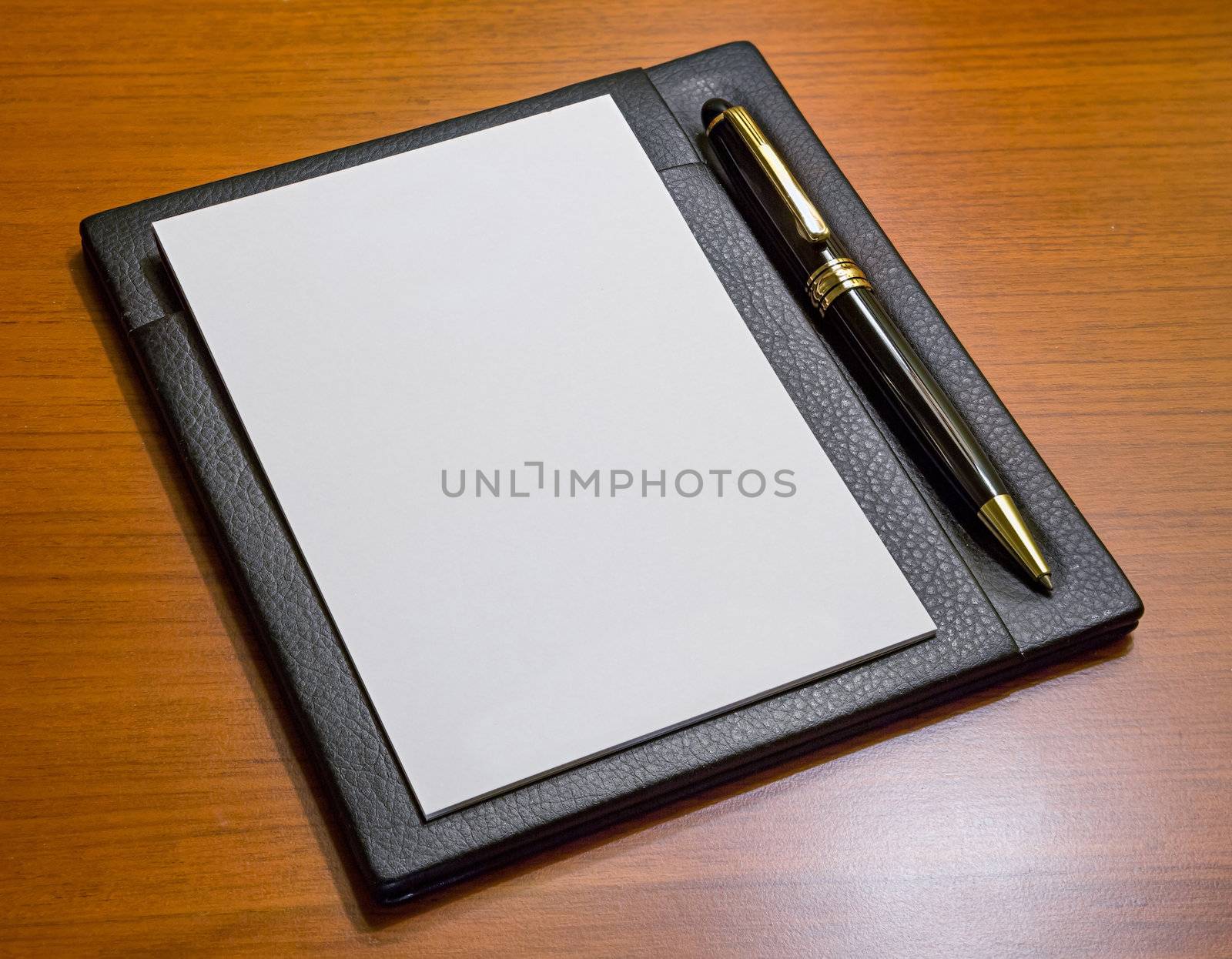 Elegance Note Paper with luxury pen in leather holder on wood table
