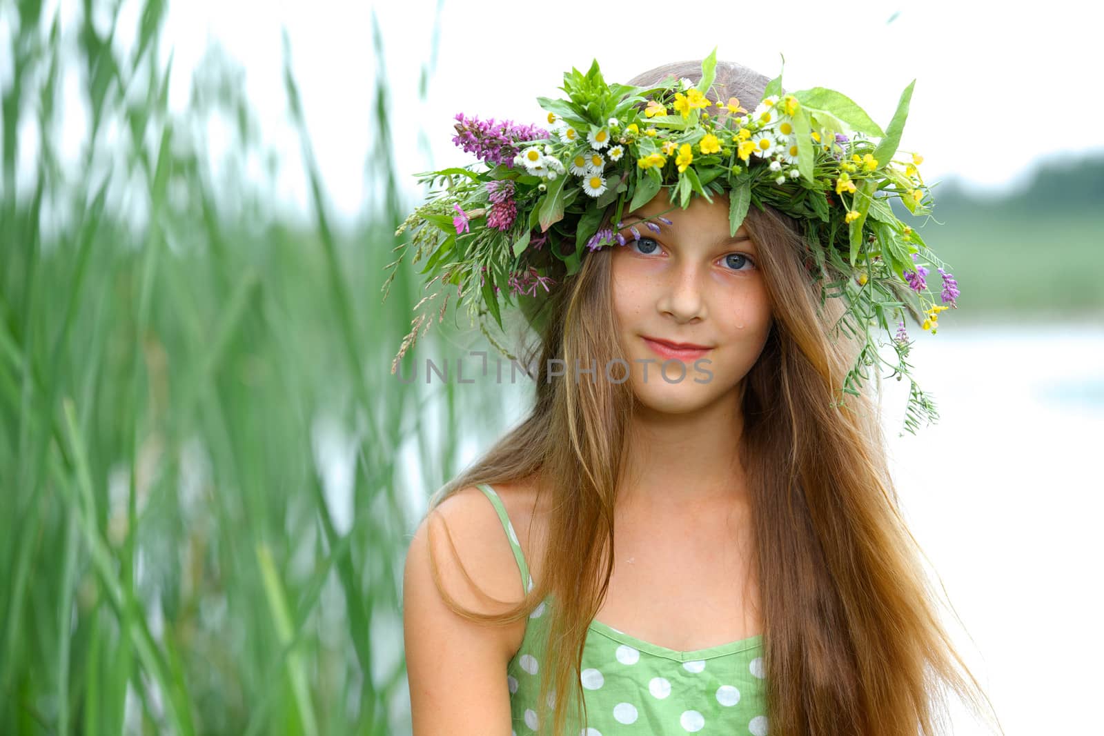 Clouse-up spring portrait beautiful girl with wreath of flowers