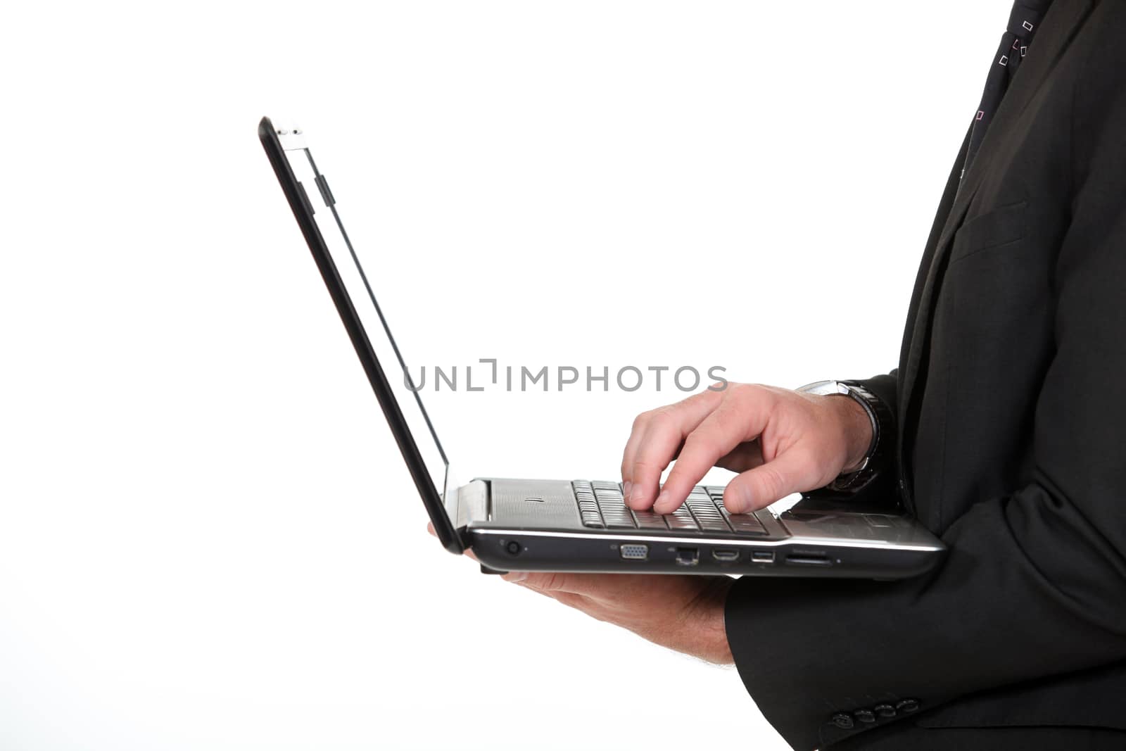 Businessman typing on laptop keyboard by phovoir