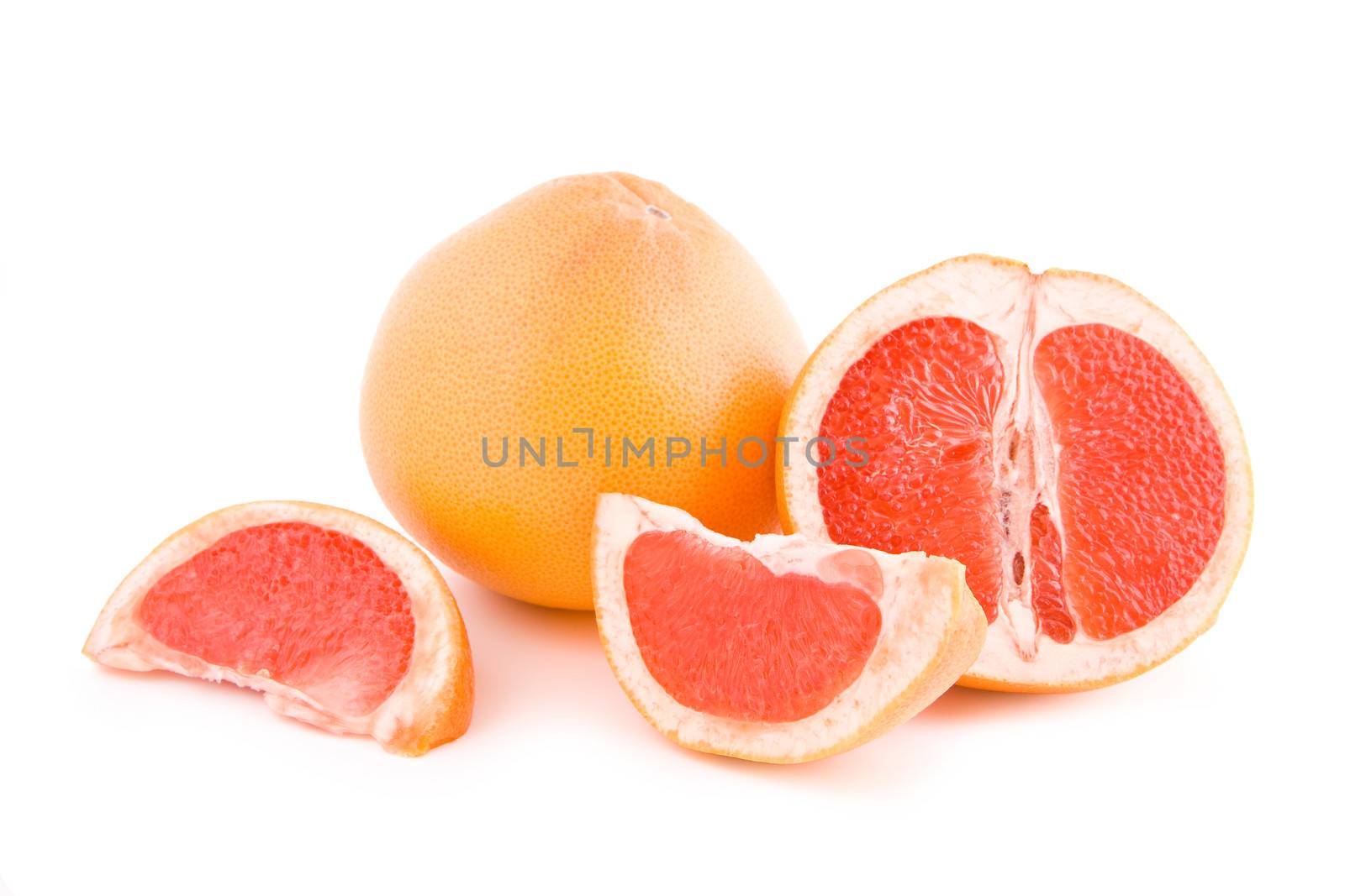 Fresh juicy red grapefruits parts isolated on white