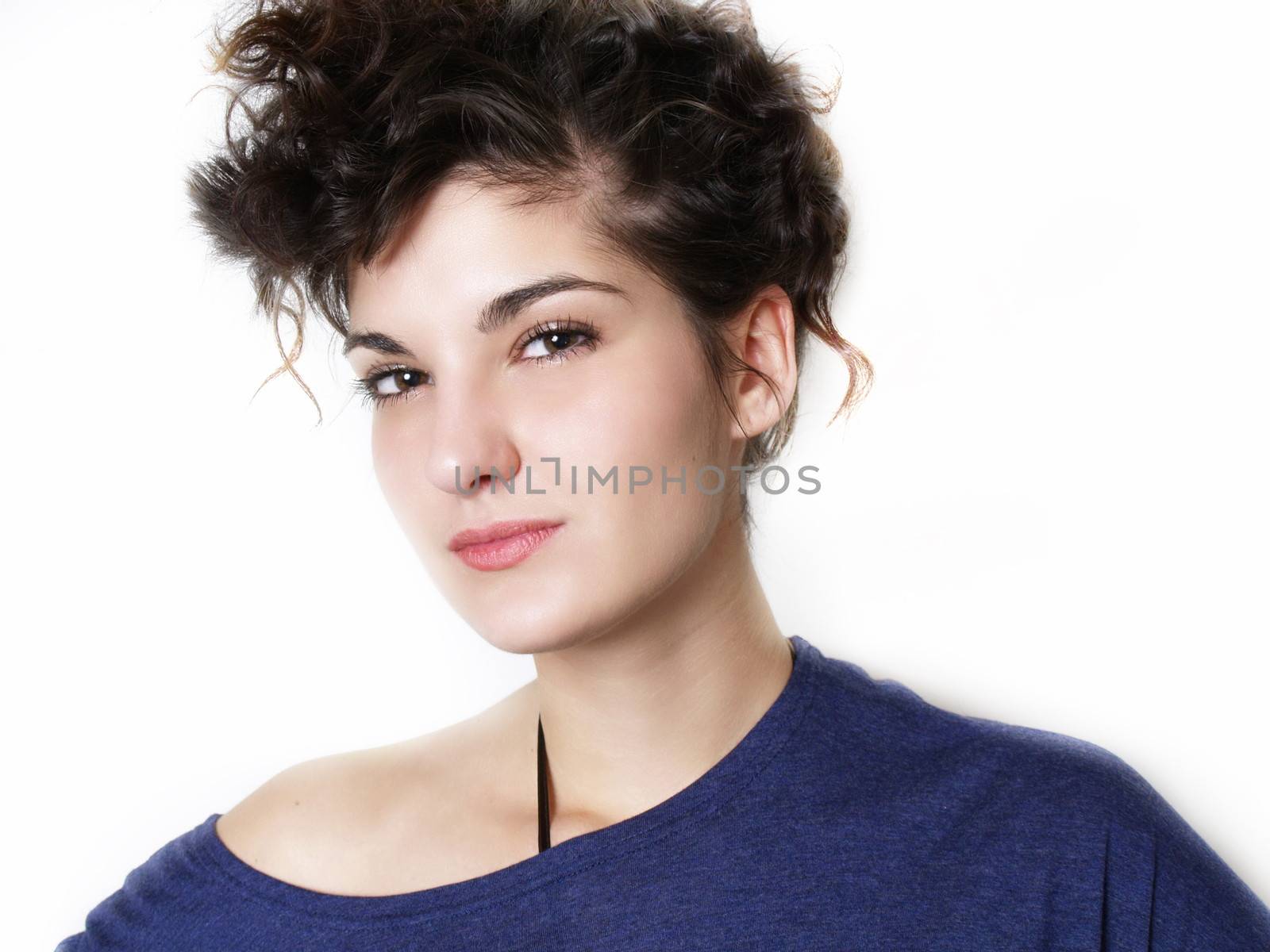 Young woman in blue t-shirt posing by anderm