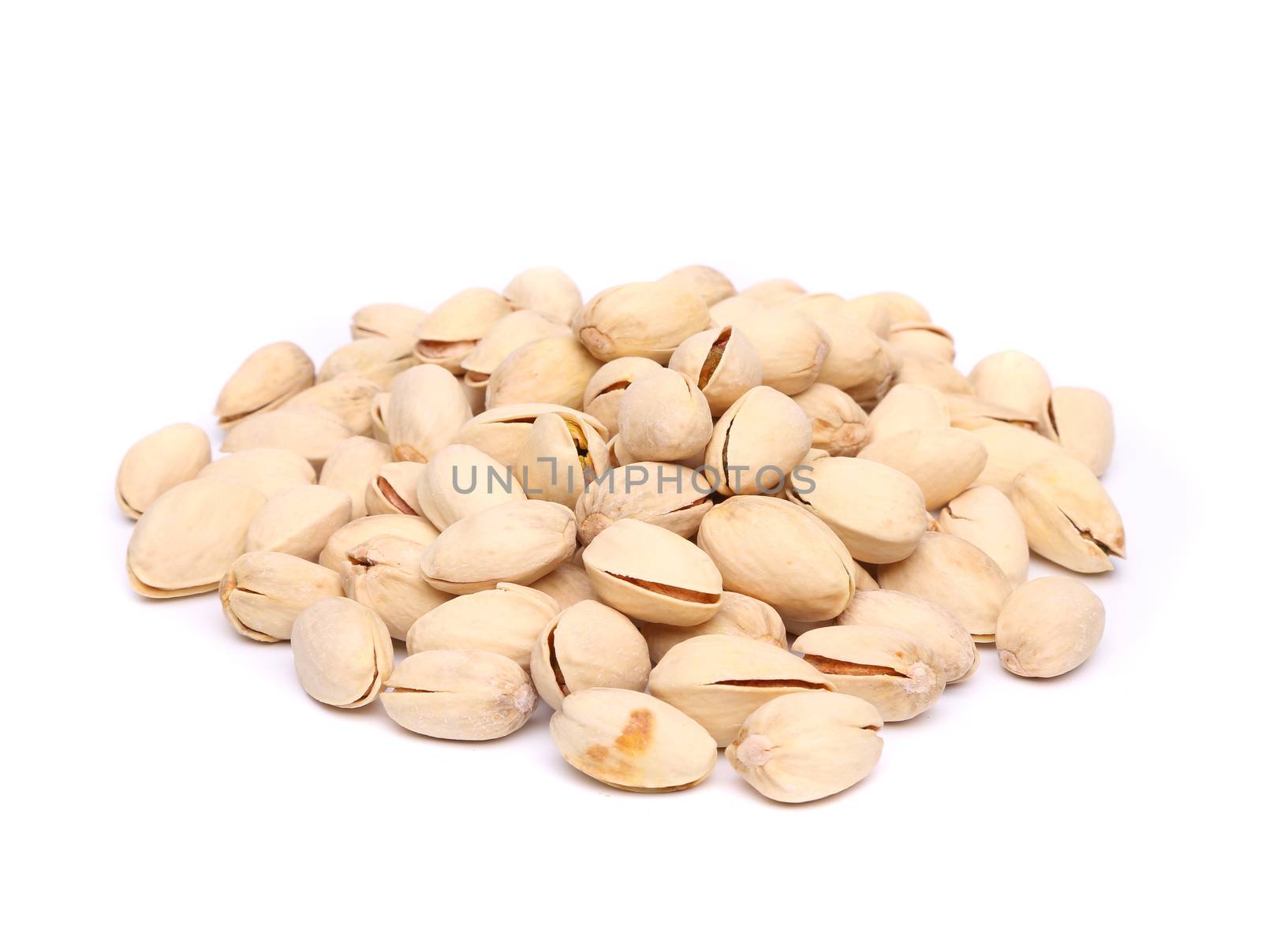 A pistachios heap on the white background close-up