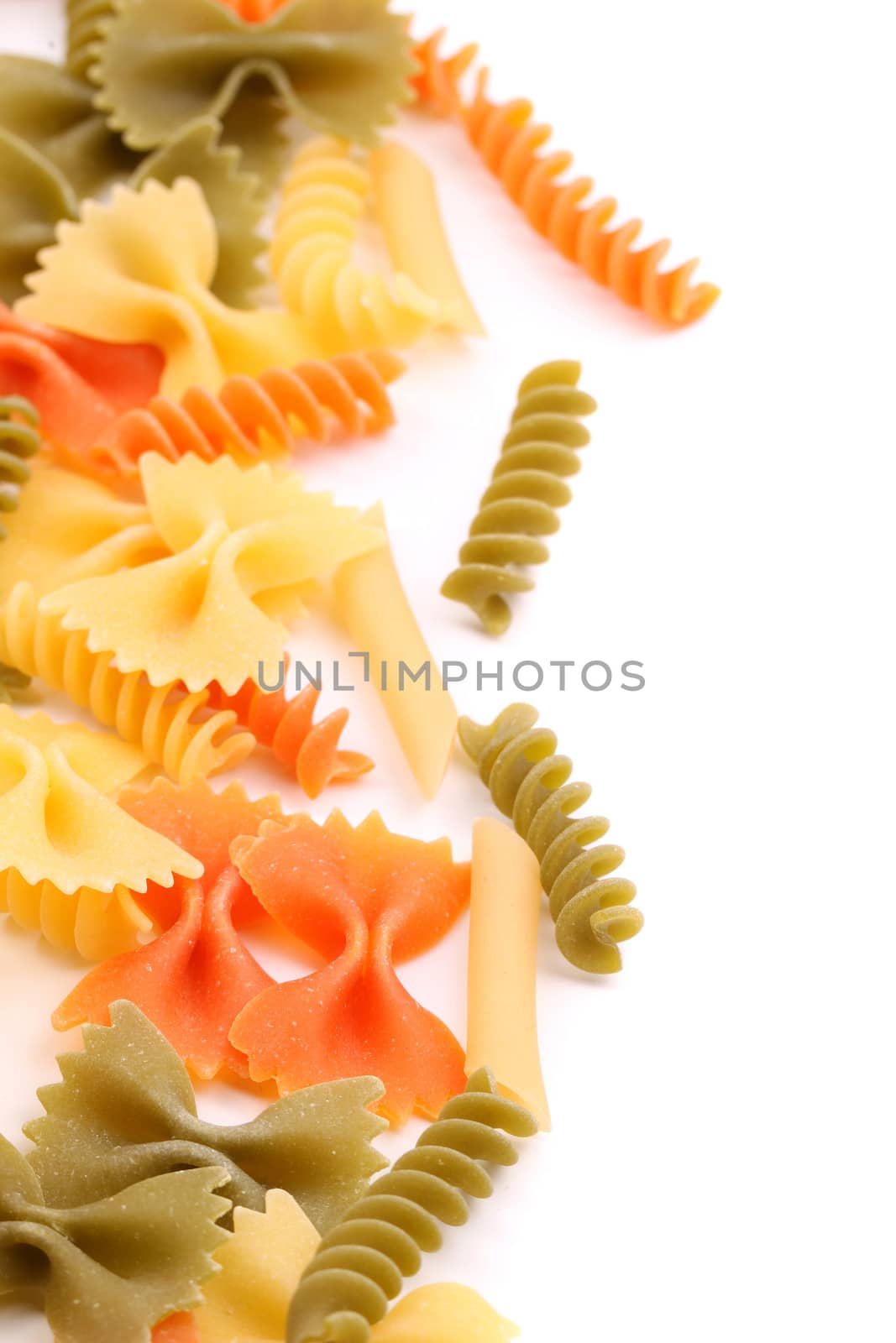 A different pasta in three colors close-up are located right on the white background.