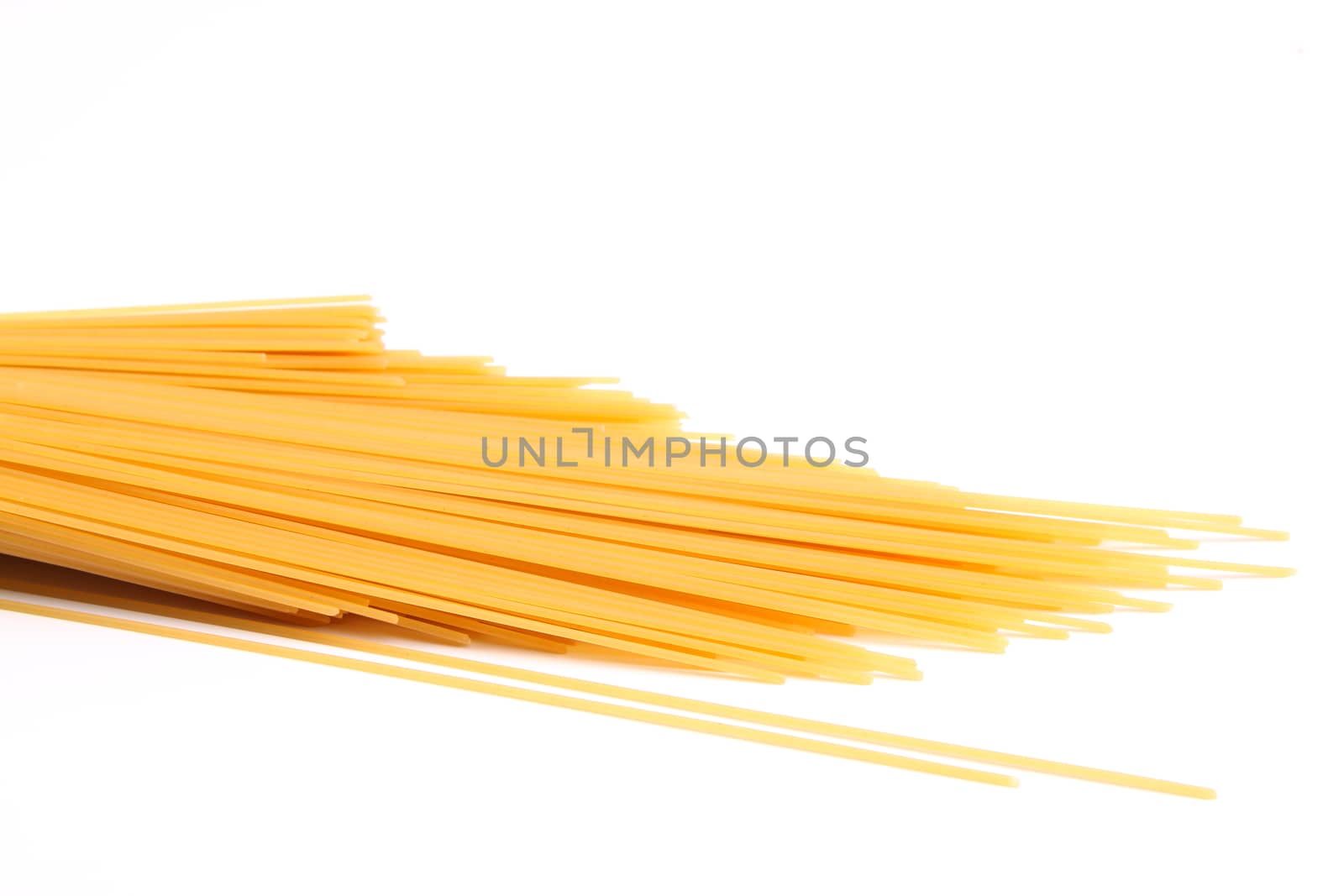 uncooked spaghetti close-up on a white background by indigolotos