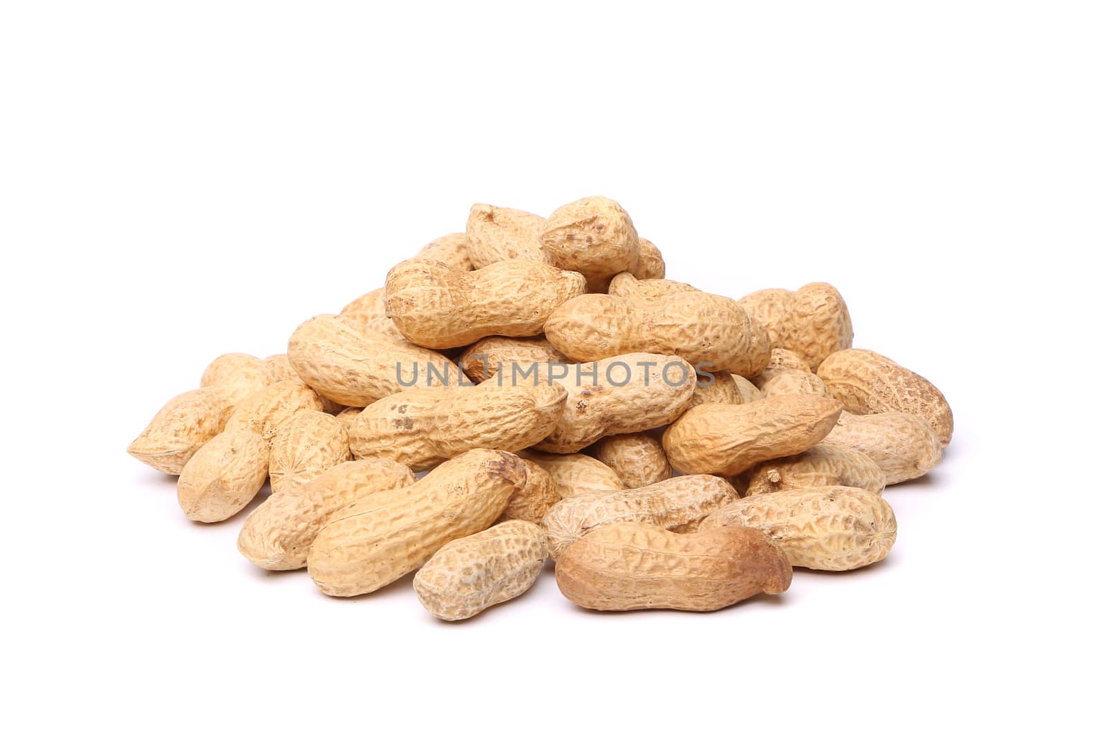 Dried peanuts in closeup on the white background