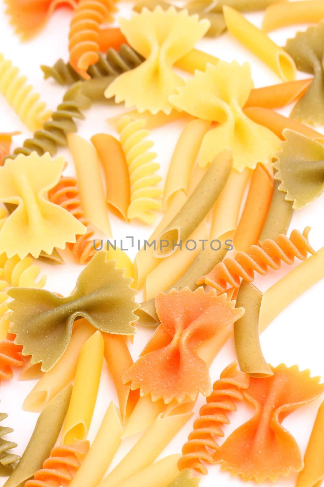 A different pasta in three colors close-up on the white background.