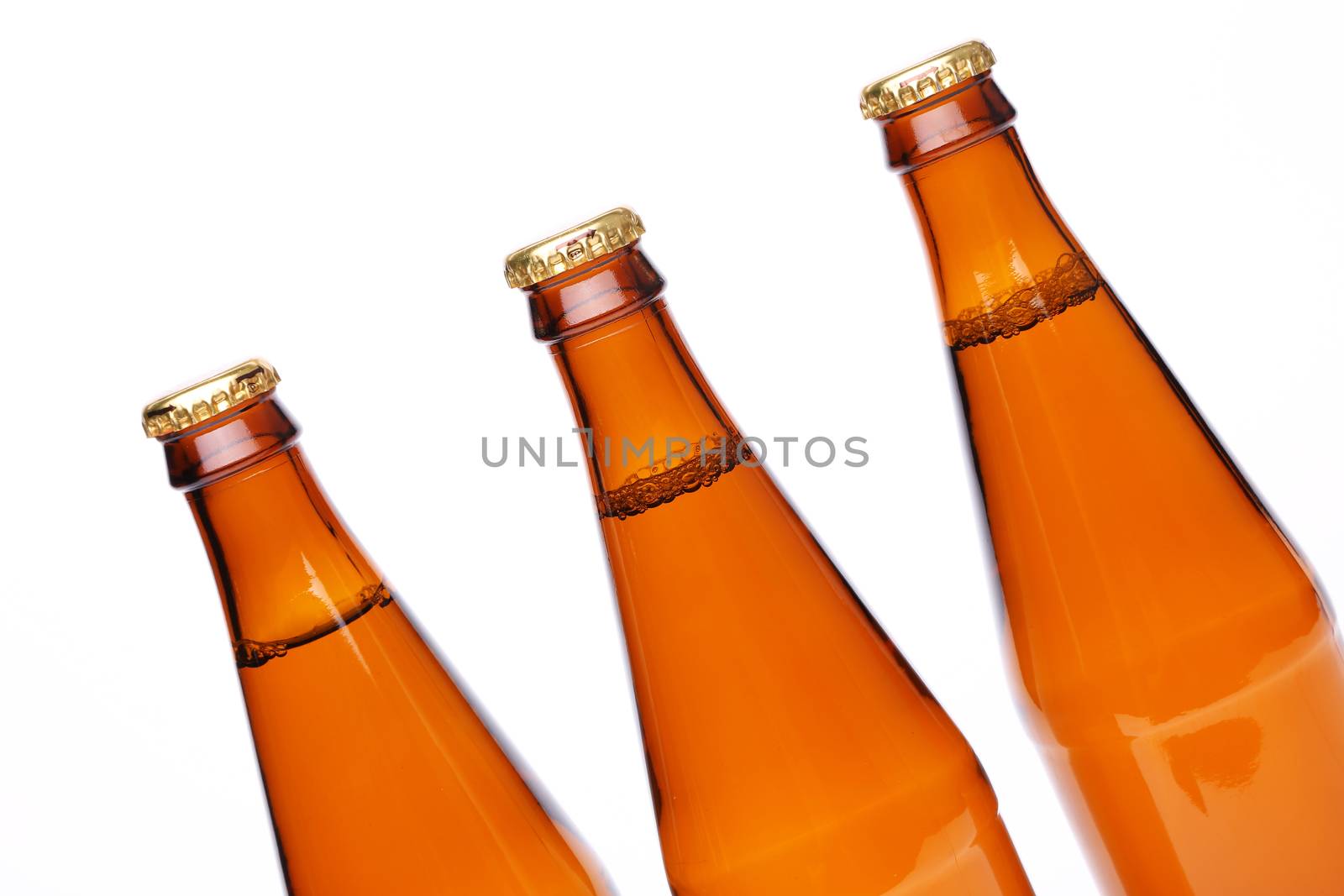 Three closed bottles at an angle, iIsolated on white.