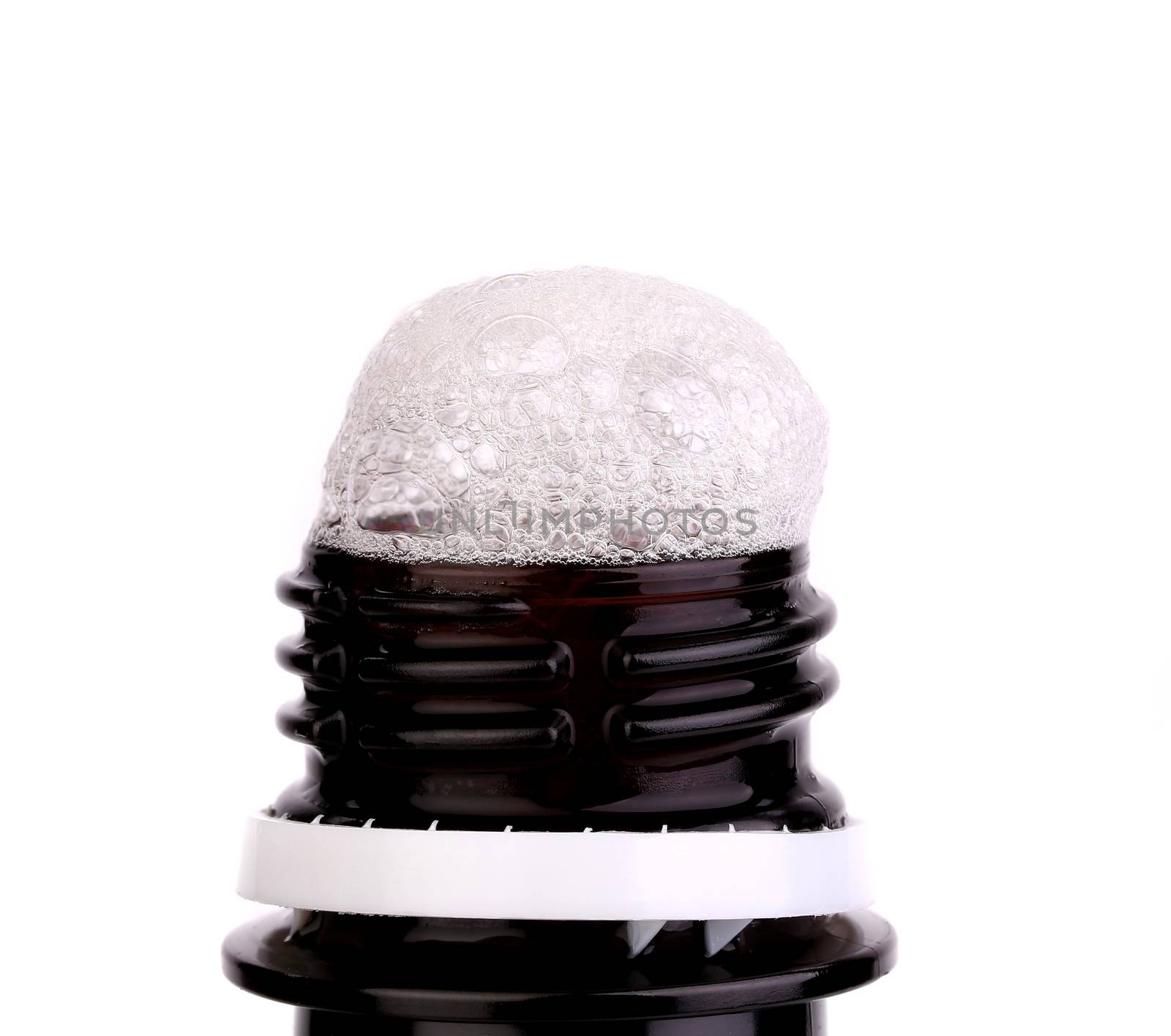 Froth cap of open beer bottle by indigolotos