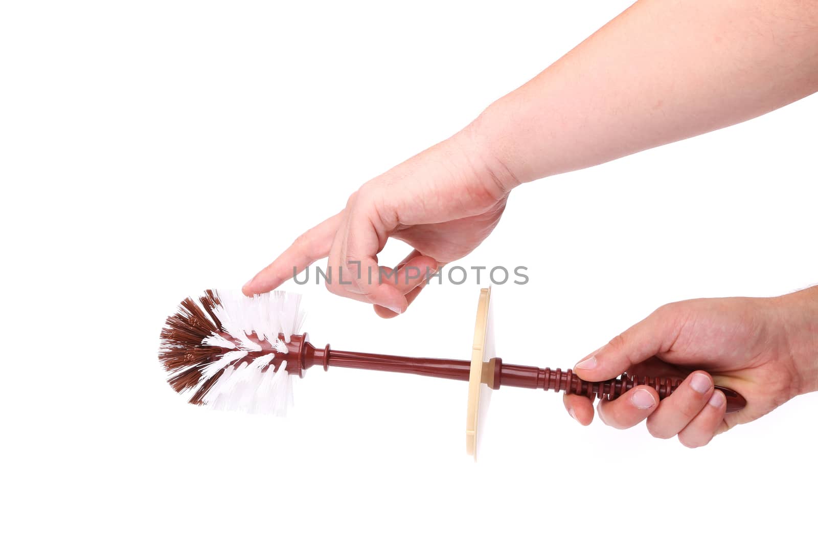 Hand holding brown toilet brush isolated on white background