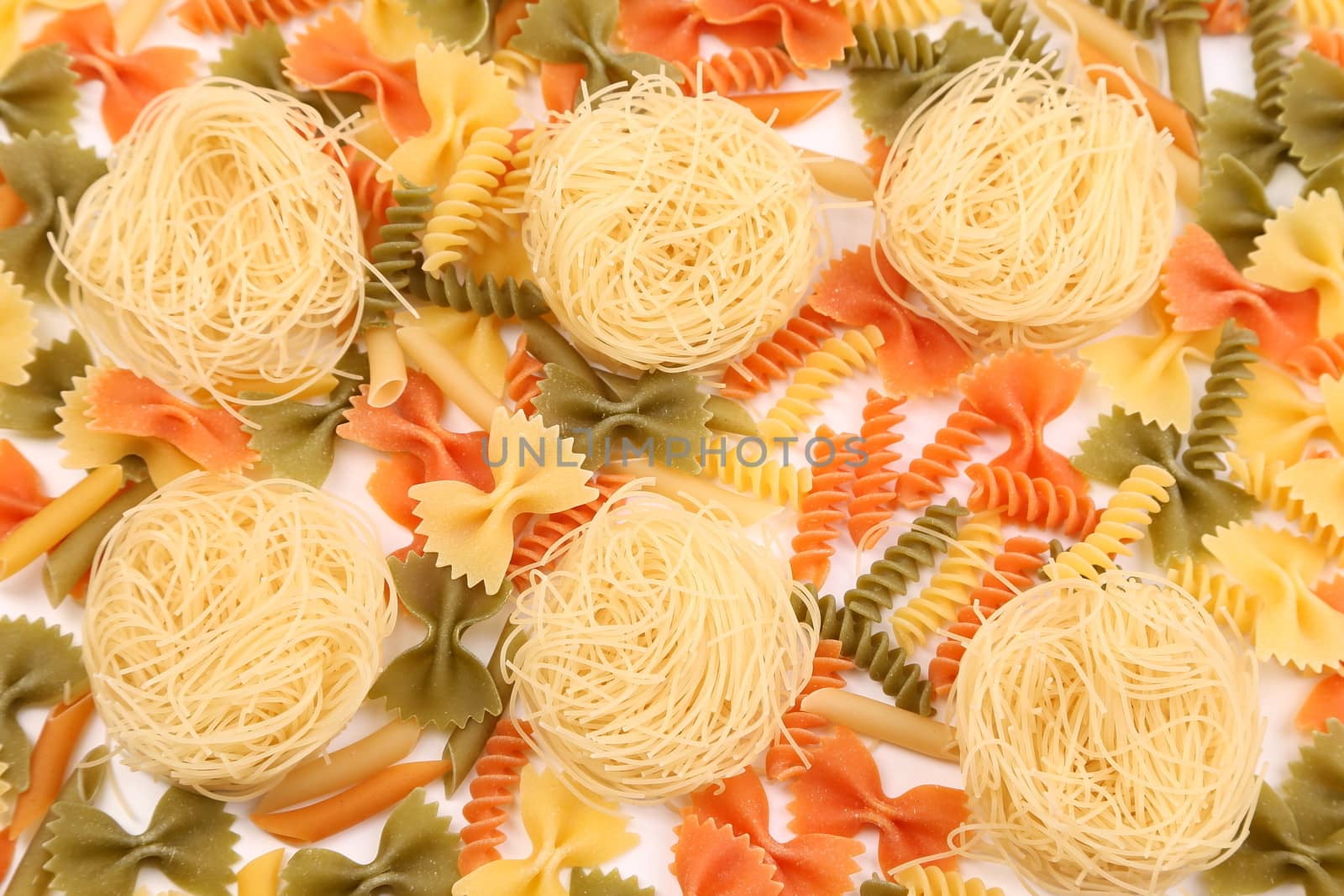 A different pasta in three colors on the white background.