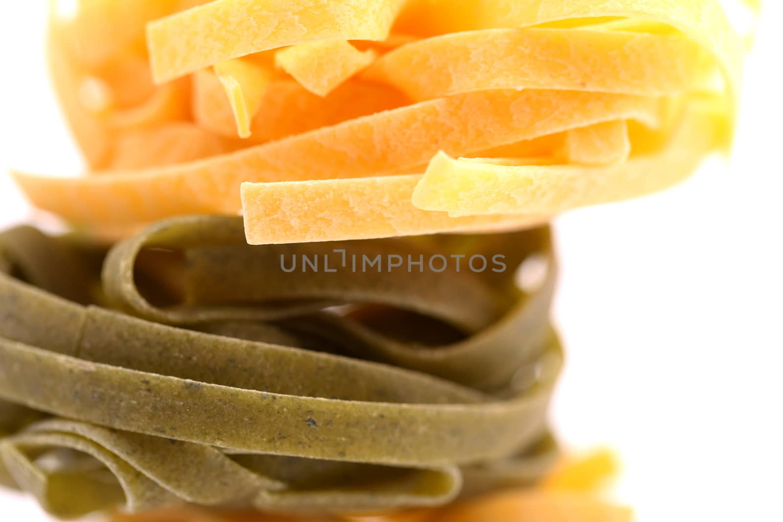 Tagliatelle paglia e fieno homemade tipycal italian pasta close-up. by indigolotos