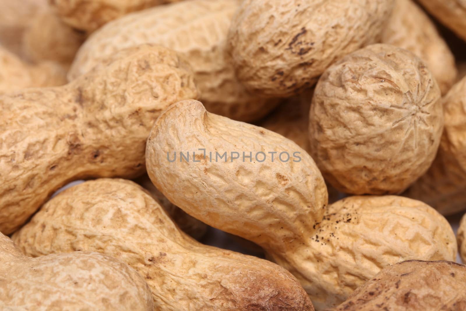 close-up of some peanuts. background by indigolotos