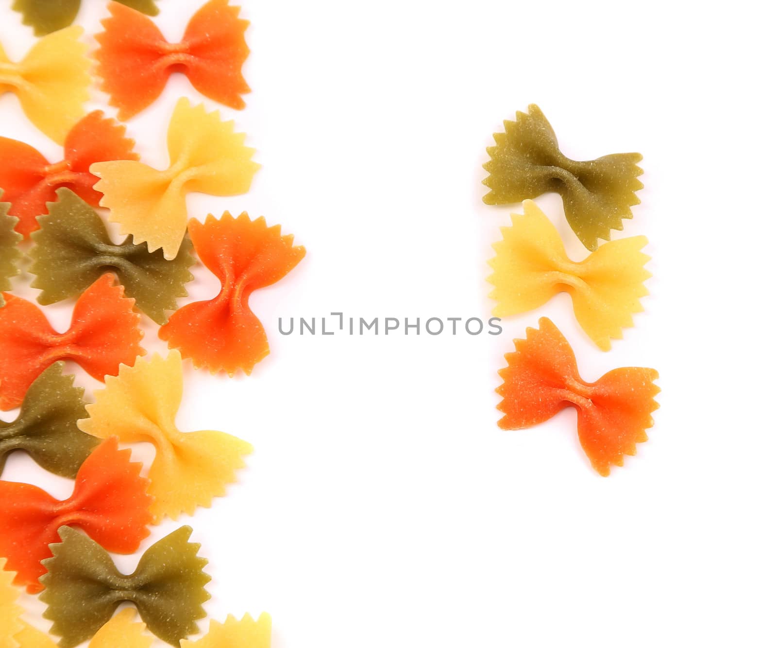 A composition of different pasta in three colors on the white background.